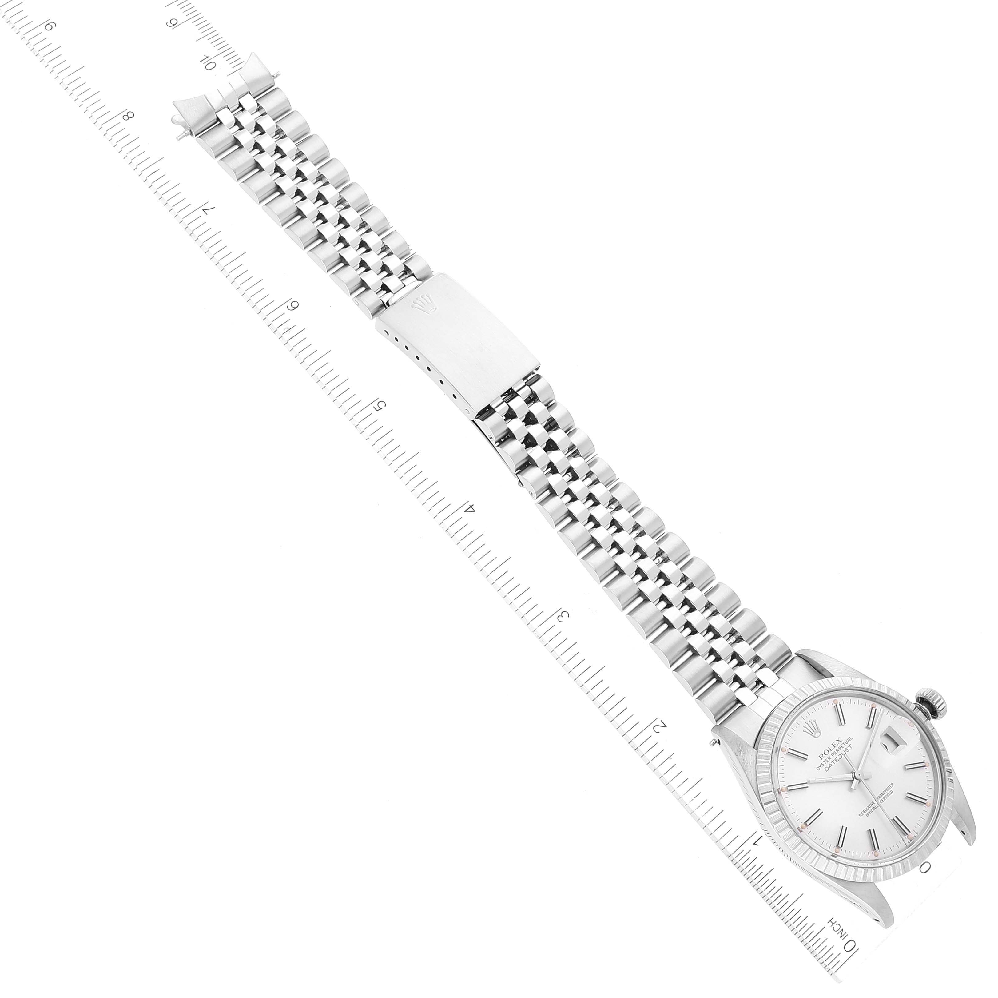 This image displays a Rolex Datejust 16030 Men's Stainless Steel Silver Dial 16030 Men's Stainless Steel Silver Dial watch at an oblique angle, emphasizing its dial, bracelet, and clasp positioned alongside a ruler.