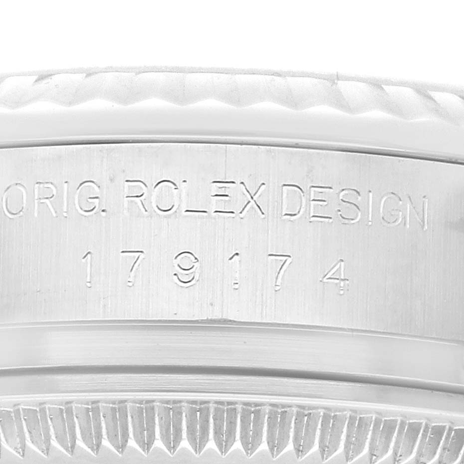 The image shows a close-up of the serial number and bezel of a Rolex Datejust 179174 Women's Stainless Steel Black Dial 179174 Women's Stainless Steel Black Dial watch.