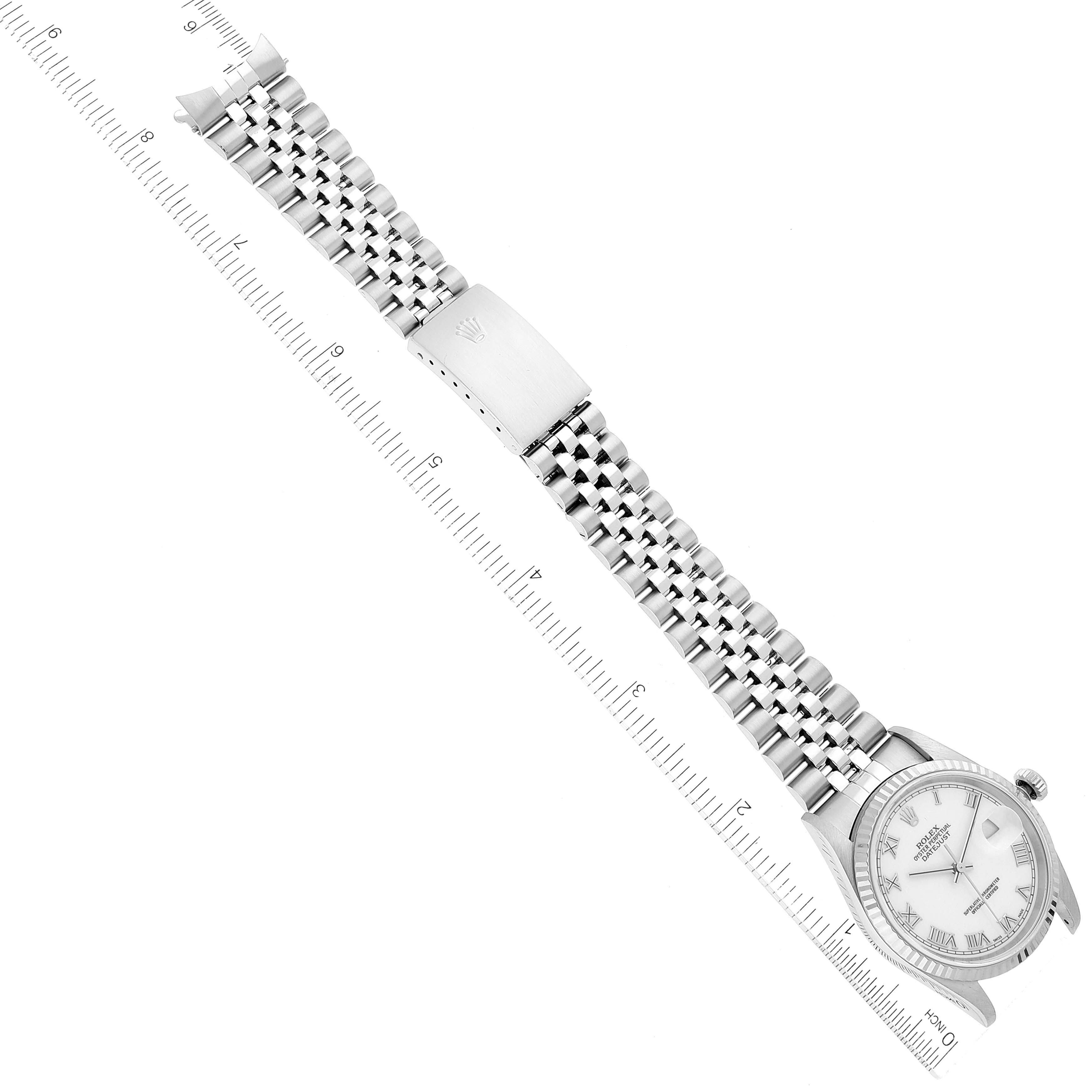 The image displays a Rolex Datejust 16234 Men's Stainless Steel White Dial 16234 Men's Stainless Steel White Dial watch laid flat, showcasing its face, stainless steel bracelet, and clasp with a ruler for scale.