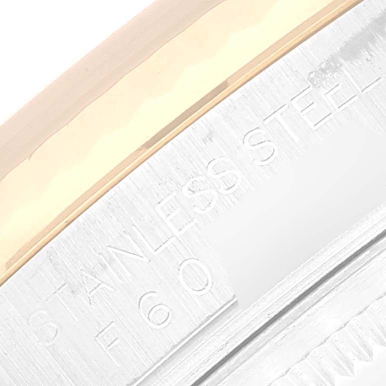 This image shows a close-up view of the stainless steel and gold bezel of a Rolex Datejust 116233 Men's Steel and Gold (two tone) Black Dial 116233 Men's Steel and Gold (two tone) Black Dial watch.