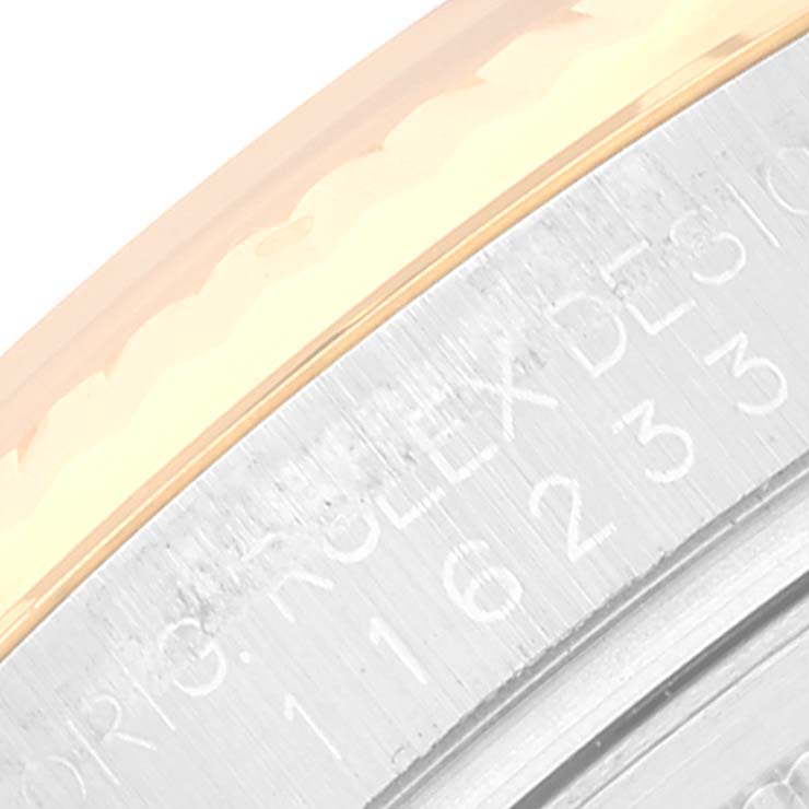 The image shows a close-up of the side casing and part of the bezel of a Rolex Datejust 116233 Men's Steel and Gold (two tone) Black Dial 116233 Men's Steel and Gold (two tone) Black Dial model.