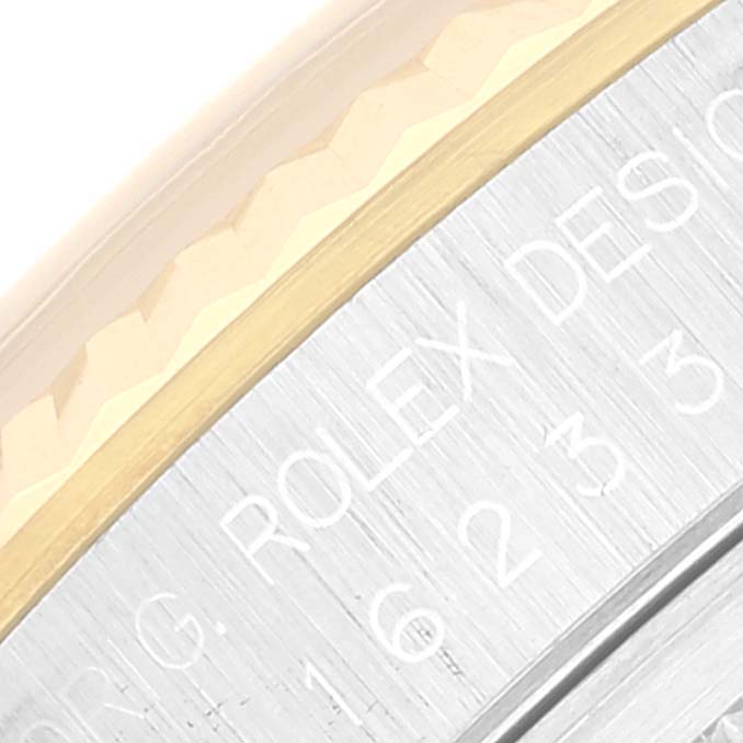 This close-up shows the engraved edge and part of the bezel of a Rolex Datejust 16233 Men's Steel and Gold (two tone) Champagne Dial 16233 Men's Steel and Gold (two tone) Champagne Dial watch.