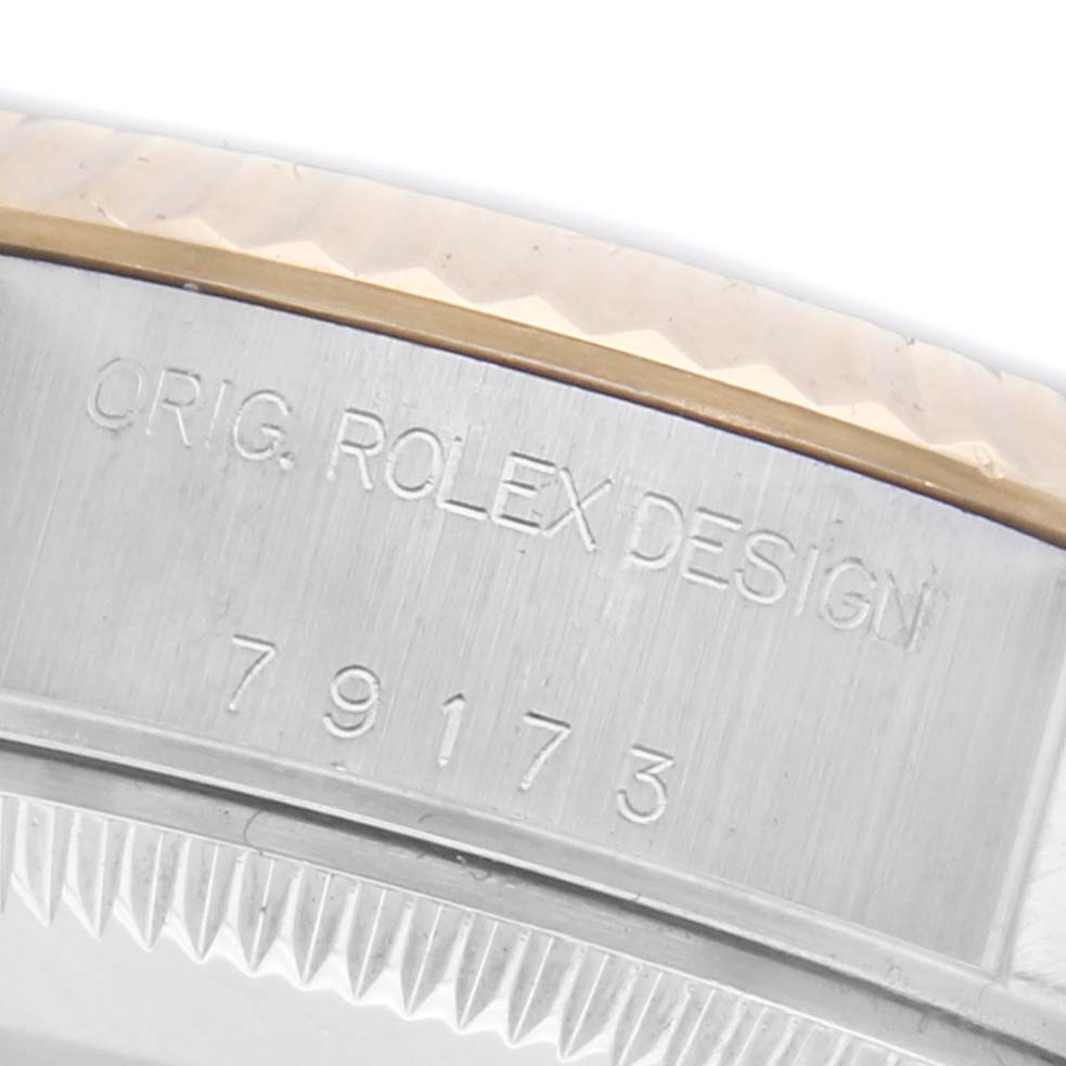 The image shows a close-up of the serial number and bezel edge of a Rolex Datejust 79173 Women's Steel and Gold (two tone) Silver Dial 79173 Women's Steel and Gold (two tone) Silver Dial watch.