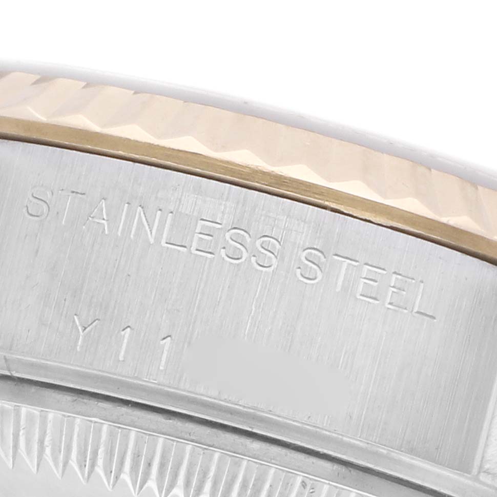 The image shows a close-up of the side of a Rolex Datejust 79173 Women's Steel and Gold (two tone) Silver Dial 79173 Women's Steel and Gold (two tone) Silver Dial, highlighting the stainless steel bezel and engraving details.