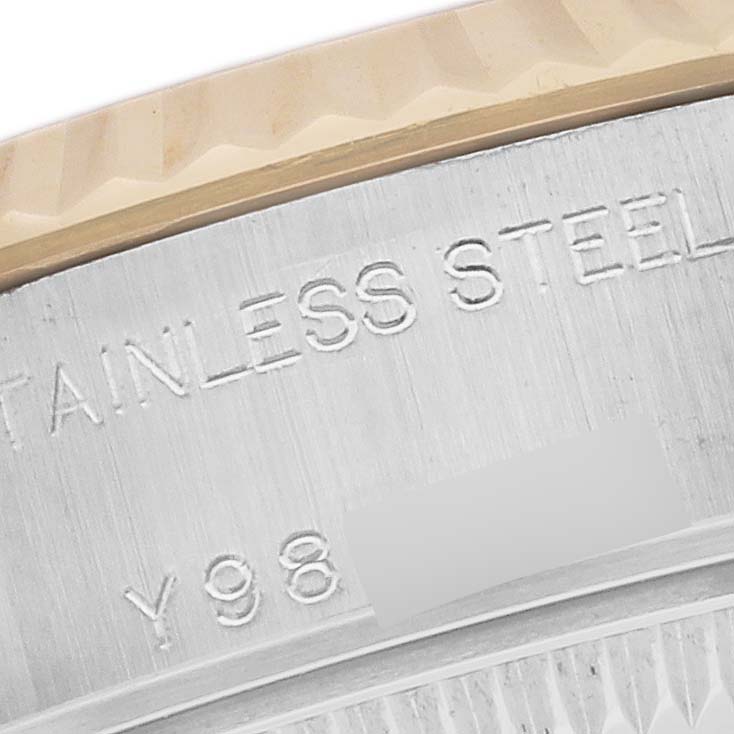 The image shows a close-up of the side of the bezel and part of the stainless steel case of a Rolex Datejust 79173 Women's Steel and Gold (two tone) Silver Dial 79173 Women's Steel and Gold (two tone) Silver Dial watch.