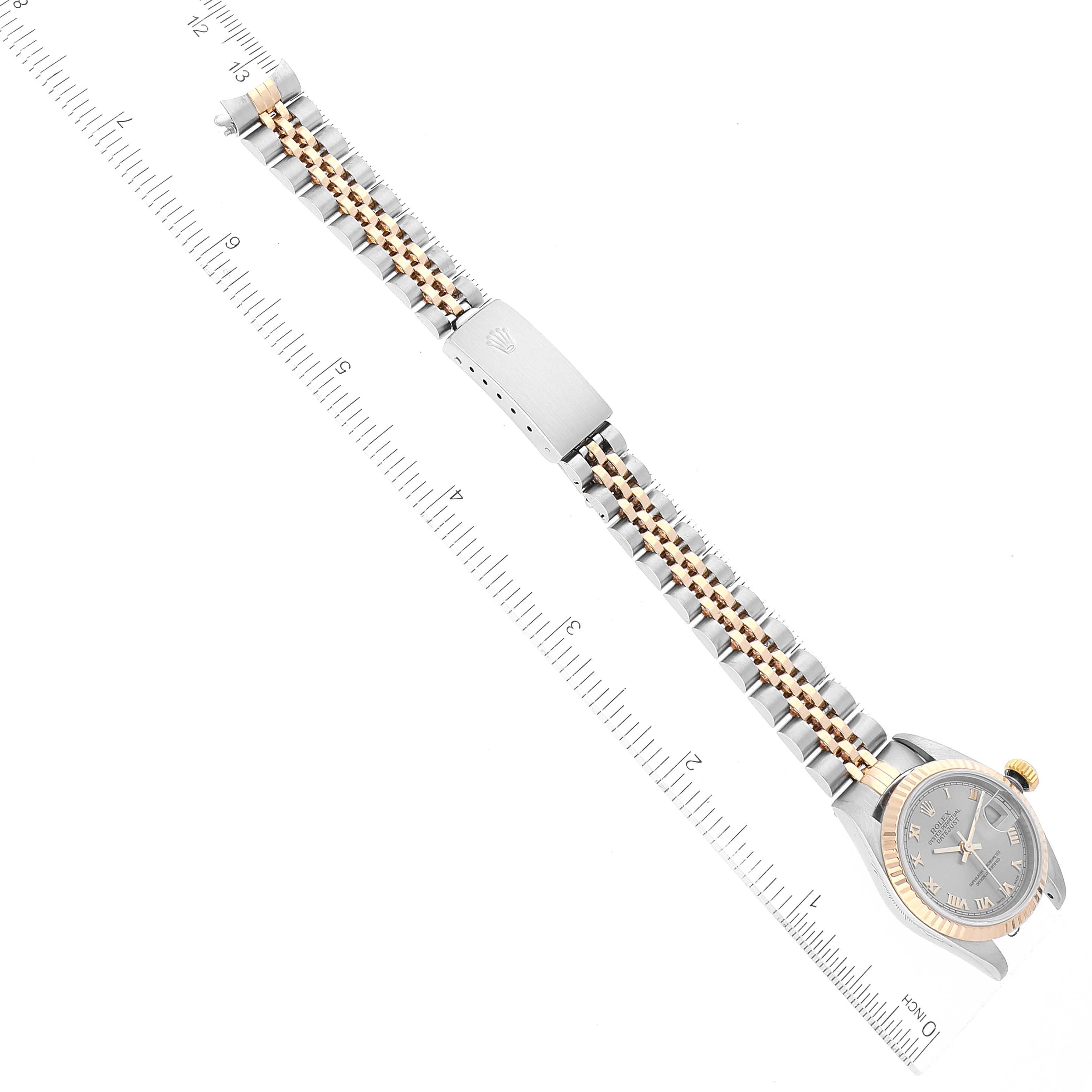 This image of the Rolex Datejust 79173 Women's Steel and Gold (two tone) Grey Dial 79173 Women's Steel and Gold (two tone) Grey Dial watch shows the watch face, bezel, and fully extended bracelet at a diagonal angle.