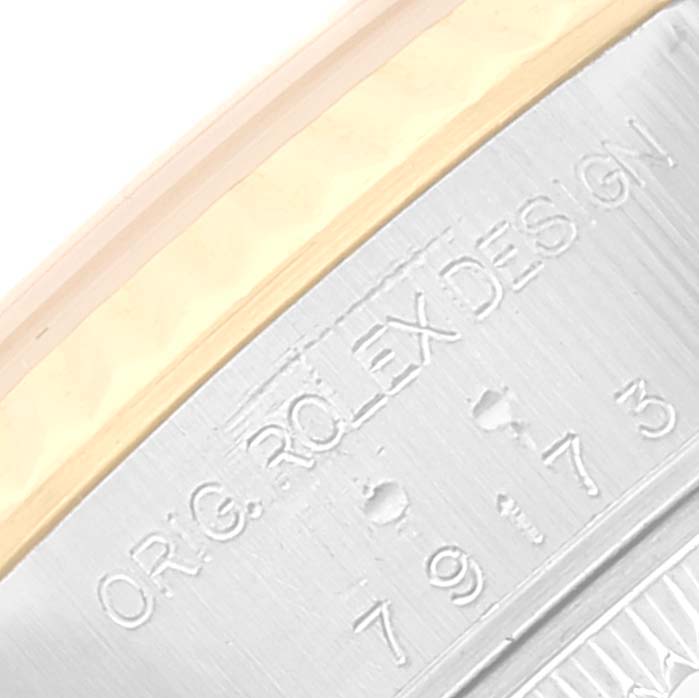 The image shows a close-up angle of the serial engraving on the bezel of a Rolex Datejust 79173 Women's Steel and Gold (two tone) Grey Dial 79173 Women's Steel and Gold (two tone) Grey Dial watch.
