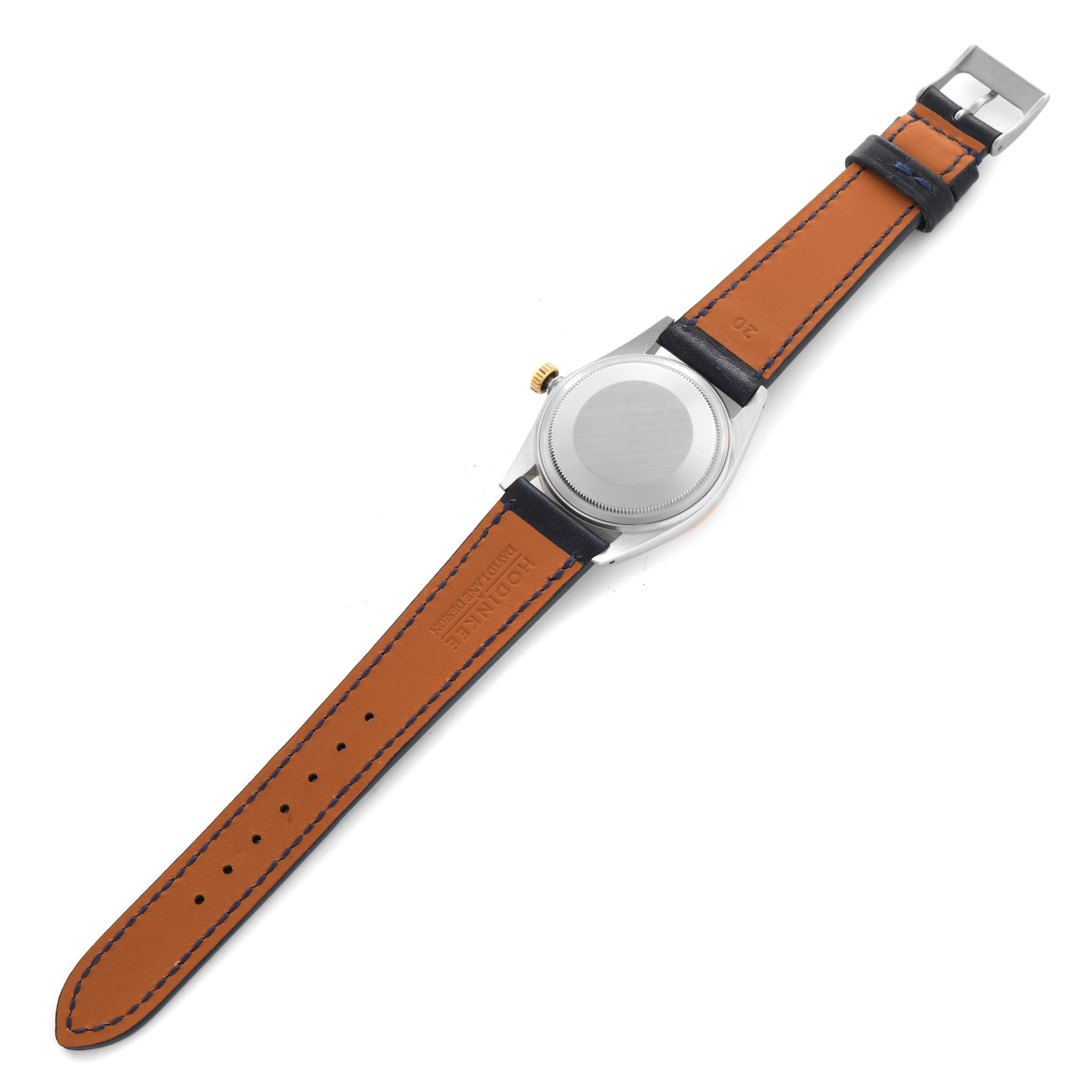 The image shows the back view of a Rolex Datejust 16013 Men's Steel and Gold (two tone) Champagne Dial 16013 Men's Steel and Gold (two tone) Champagne Dial watch with a leather band and buckle clasp.