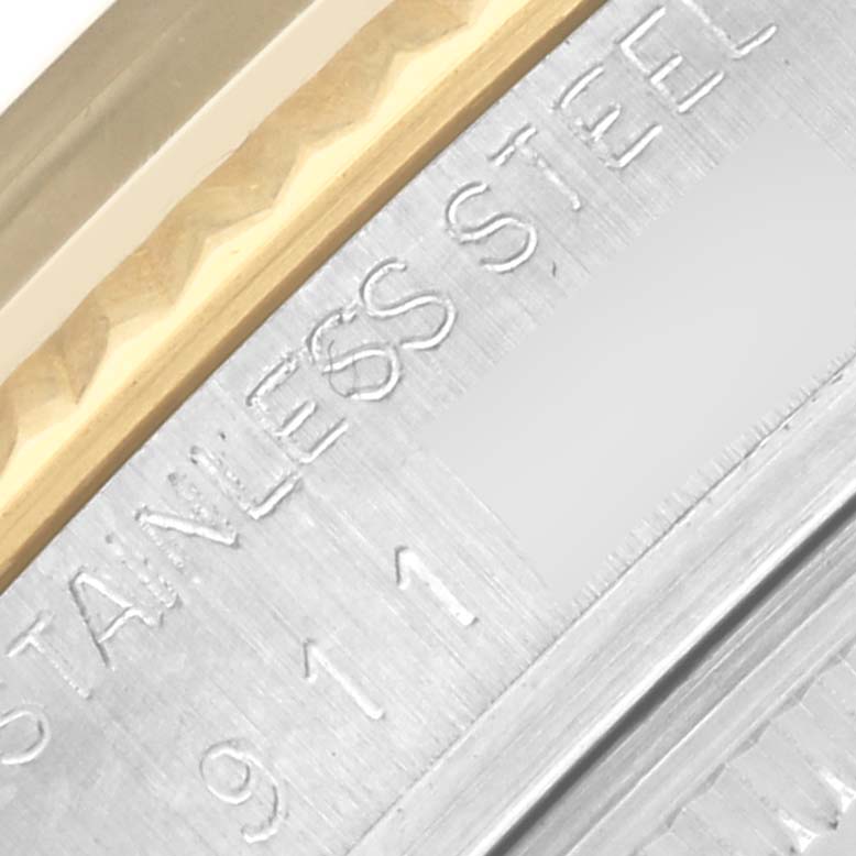 The image shows a close-up of the Rolex Datejust 16013 Men's Steel and Gold (two tone) Champagne Dial 16013 Men's Steel and Gold (two tone) Champagne Dial's bezel and case side, highlighting the gold and stainless steel parts.