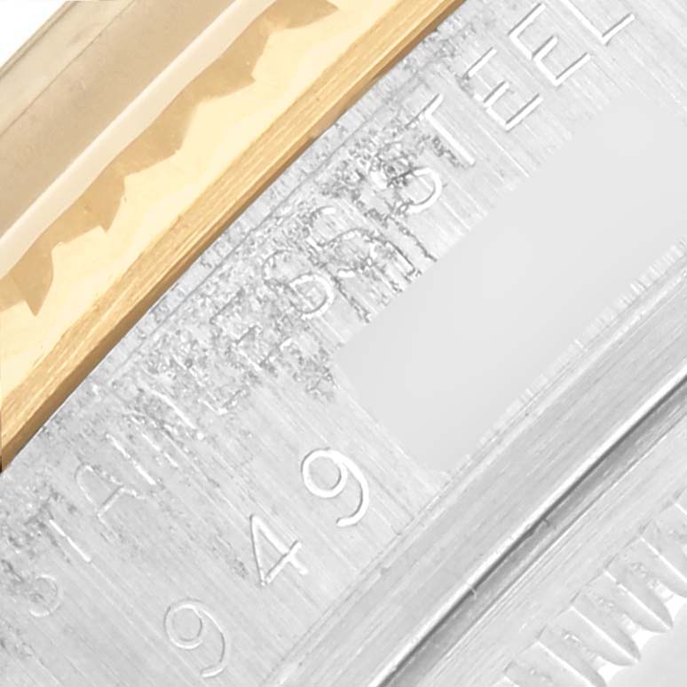 The image shows a close-up of the Rolex Datejust 16013 Men's Steel and Gold (two tone) Champagne Dial 16013 Men's Steel and Gold (two tone) Champagne Dial's fluted bezel and engraved rehaut.