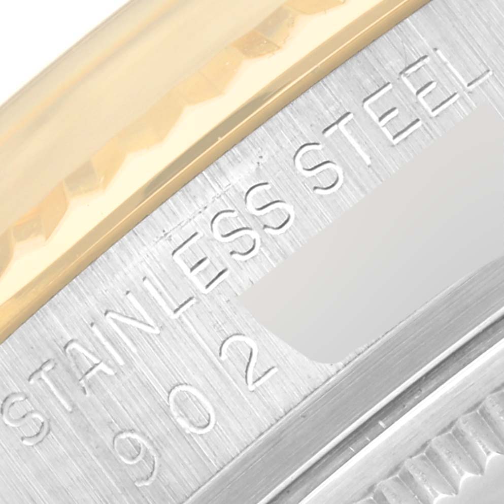 This close-up image shows the stainless steel and gold bezel of a Vintage Collection model by Rolex.