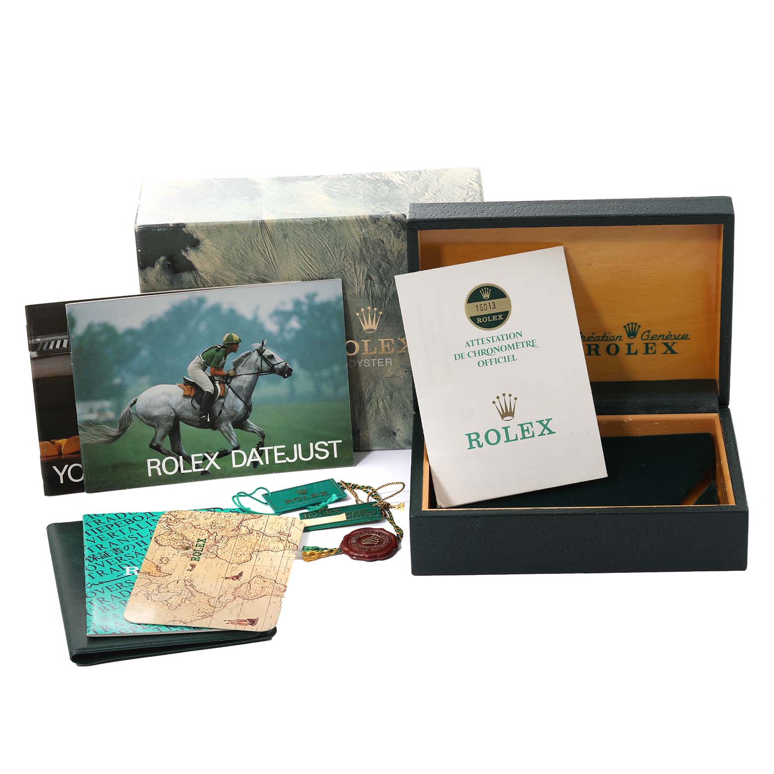 The image shows the packaging, documents, and accessories of a Vintage Collection Rolex Datejust watch.