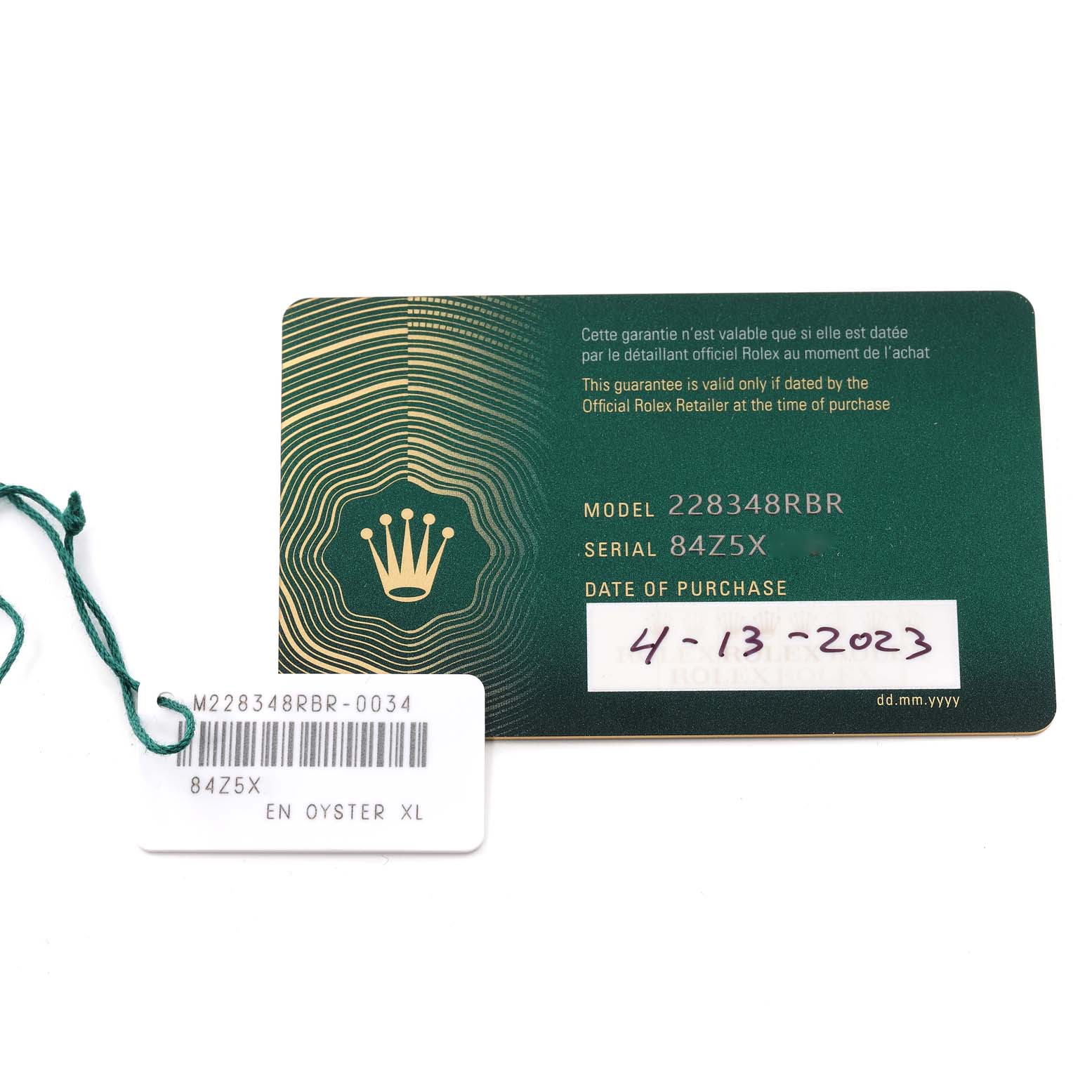 The image shows the warranty card and tag for a Rolex President 228348 Men
s Yellow Gold White Dial 228348 Men
s Yellow Gold White Dial model 228348RBR.