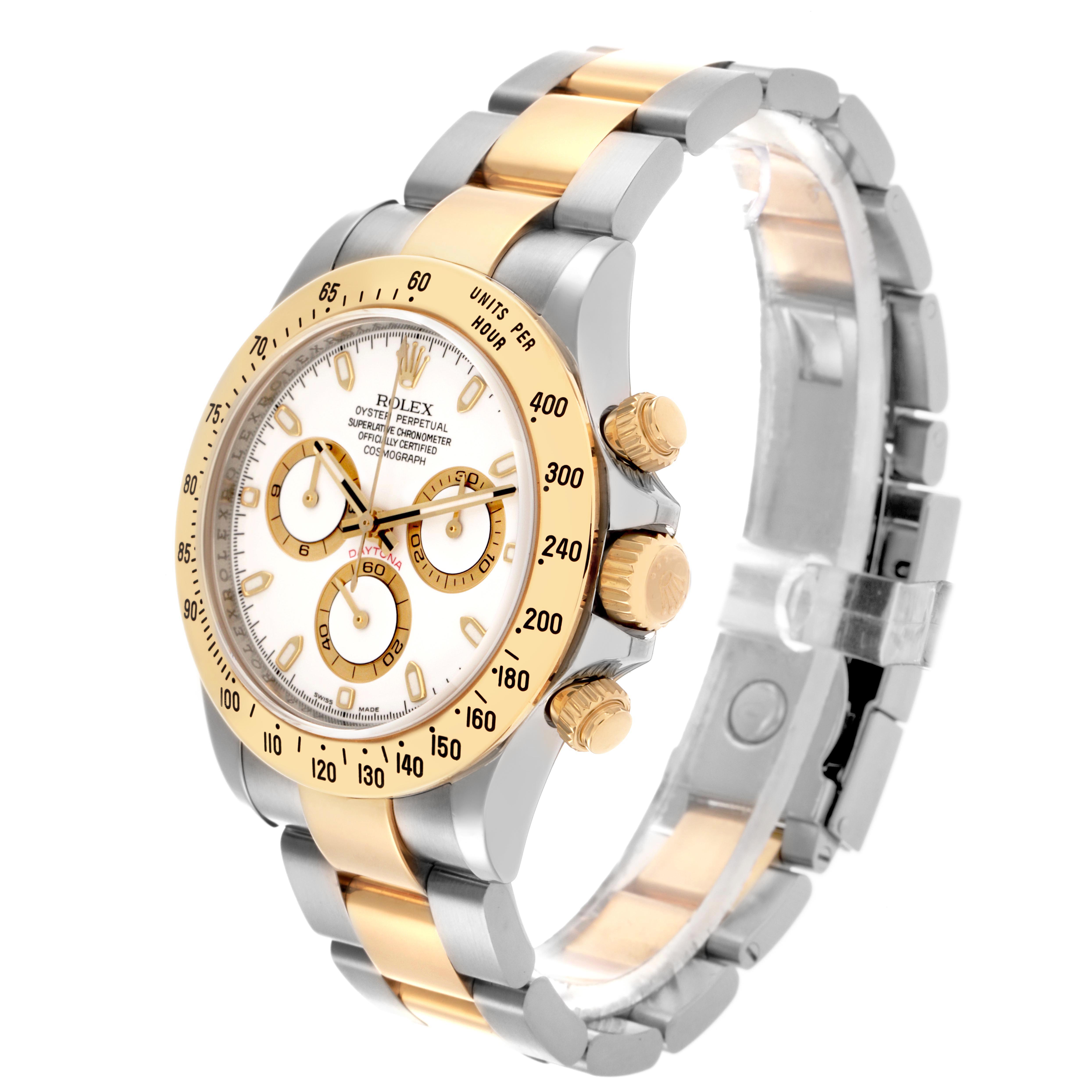 The Rolex Daytona 116523 Men's Steel and Gold (two tone) White Dial 116523 Men's Steel and Gold (two tone) White Dial watch is shown at an angled view, highlighting its gold and steel bracelet, bezel, and side pushers.