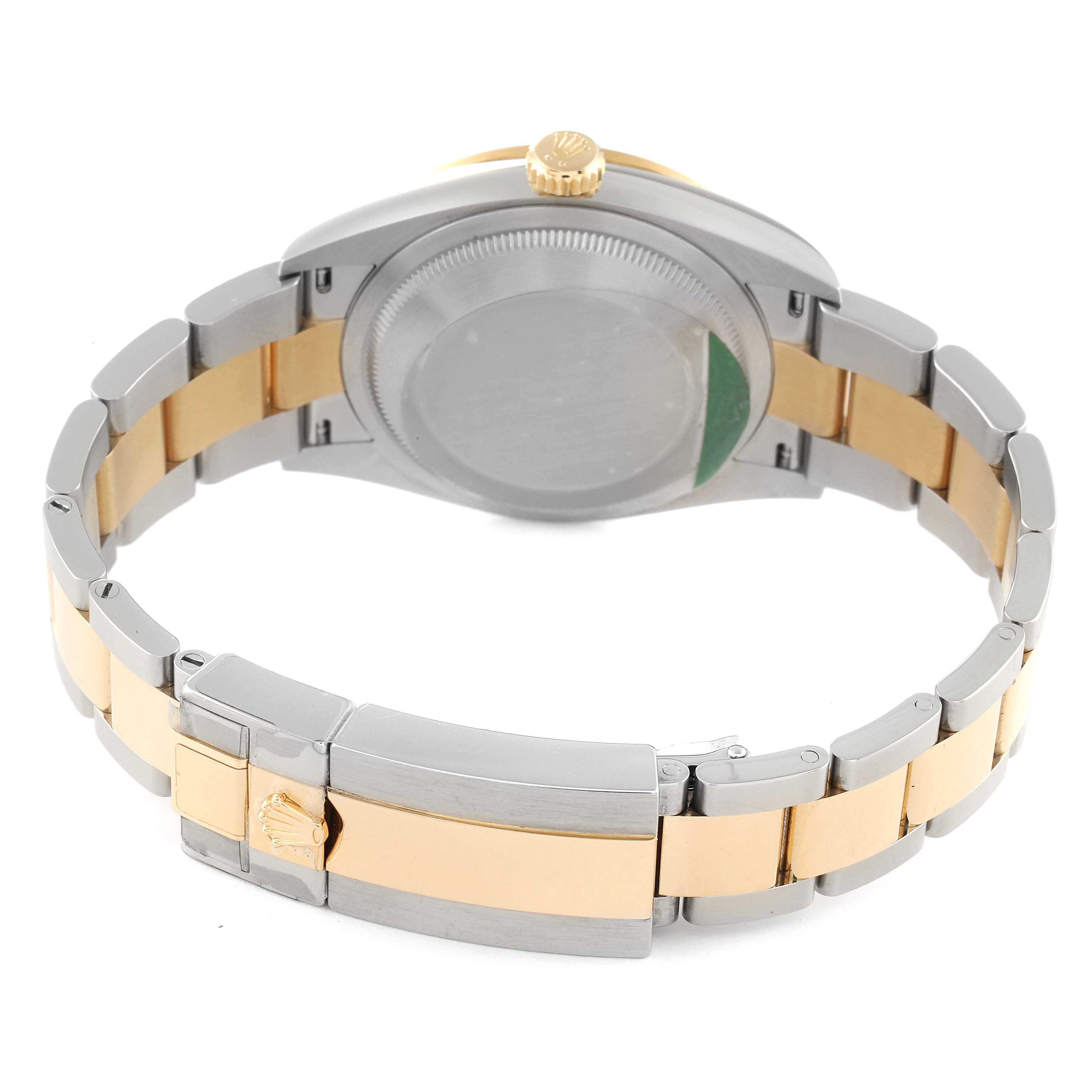 The image shows the back of a Rolex Explorer 124273 Men
s Steel and Gold (two tone) Black Dial 124273 Men
s Steel and Gold (two tone) Black Dial watch, highlighting the clasp and bracelet.