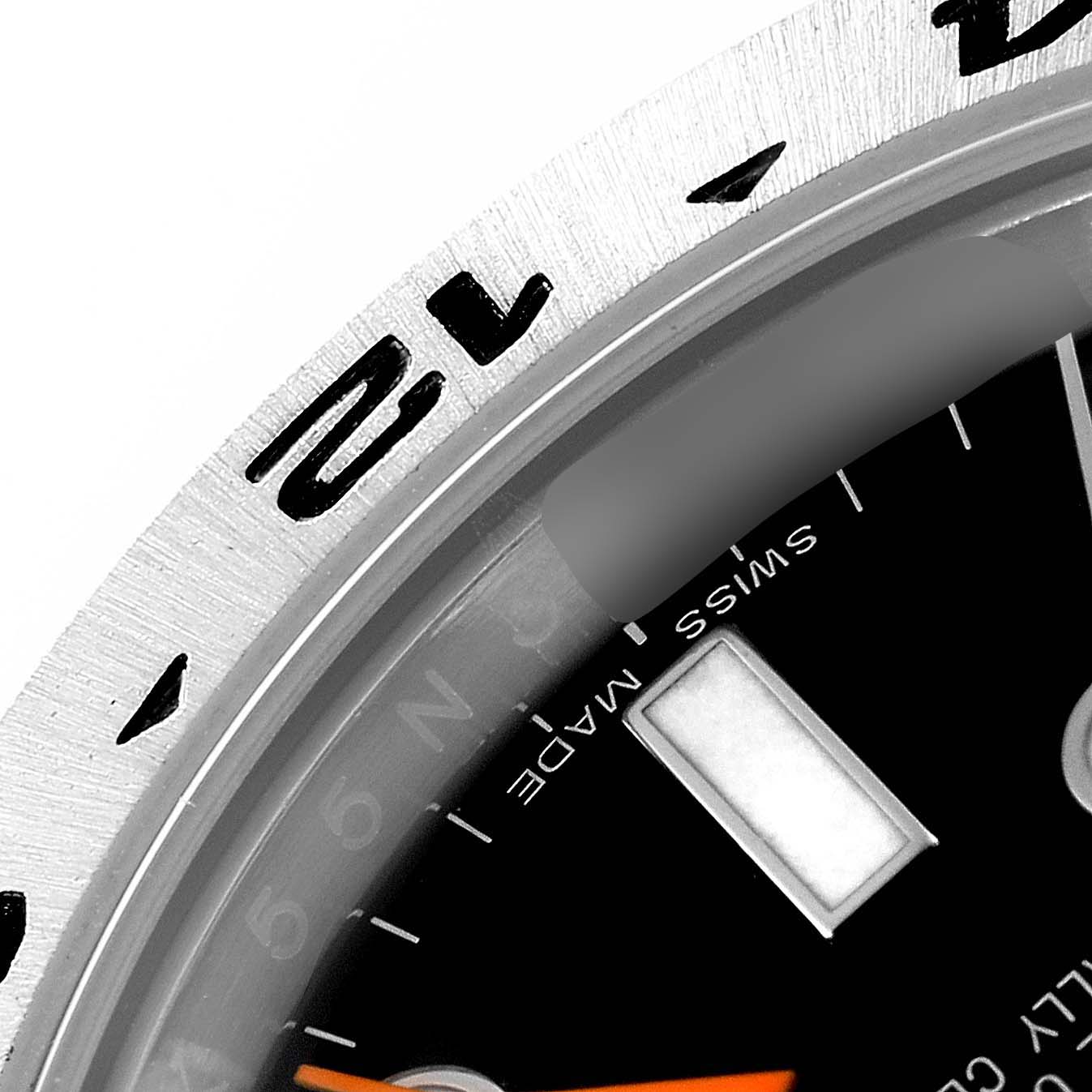 The image shows a close-up of the bezel and part of the dial of a Rolex Explorer 216570 Men
s Stainless Steel Black Dial 216570 Men
s Stainless Steel Black Dial watch.