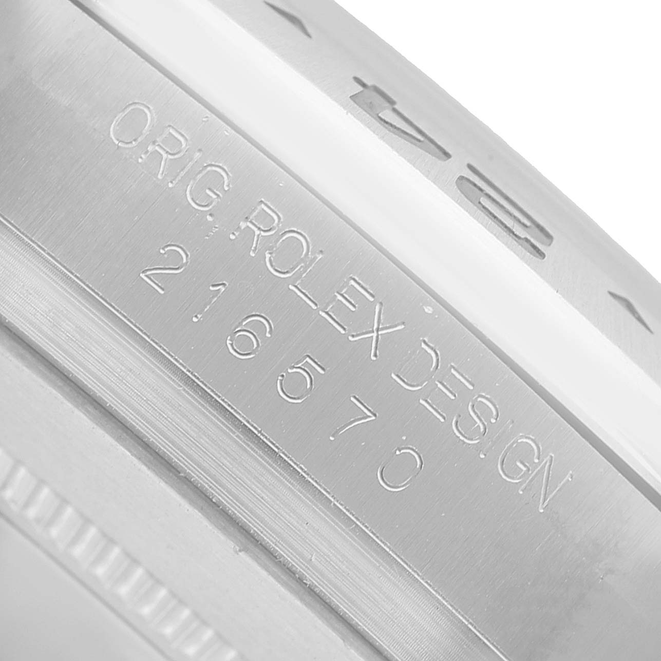 The image shows a close-up of the Rolex Explorer 216570 Men's Stainless Steel White Dial model, focusing on the engraved side of the watch case.