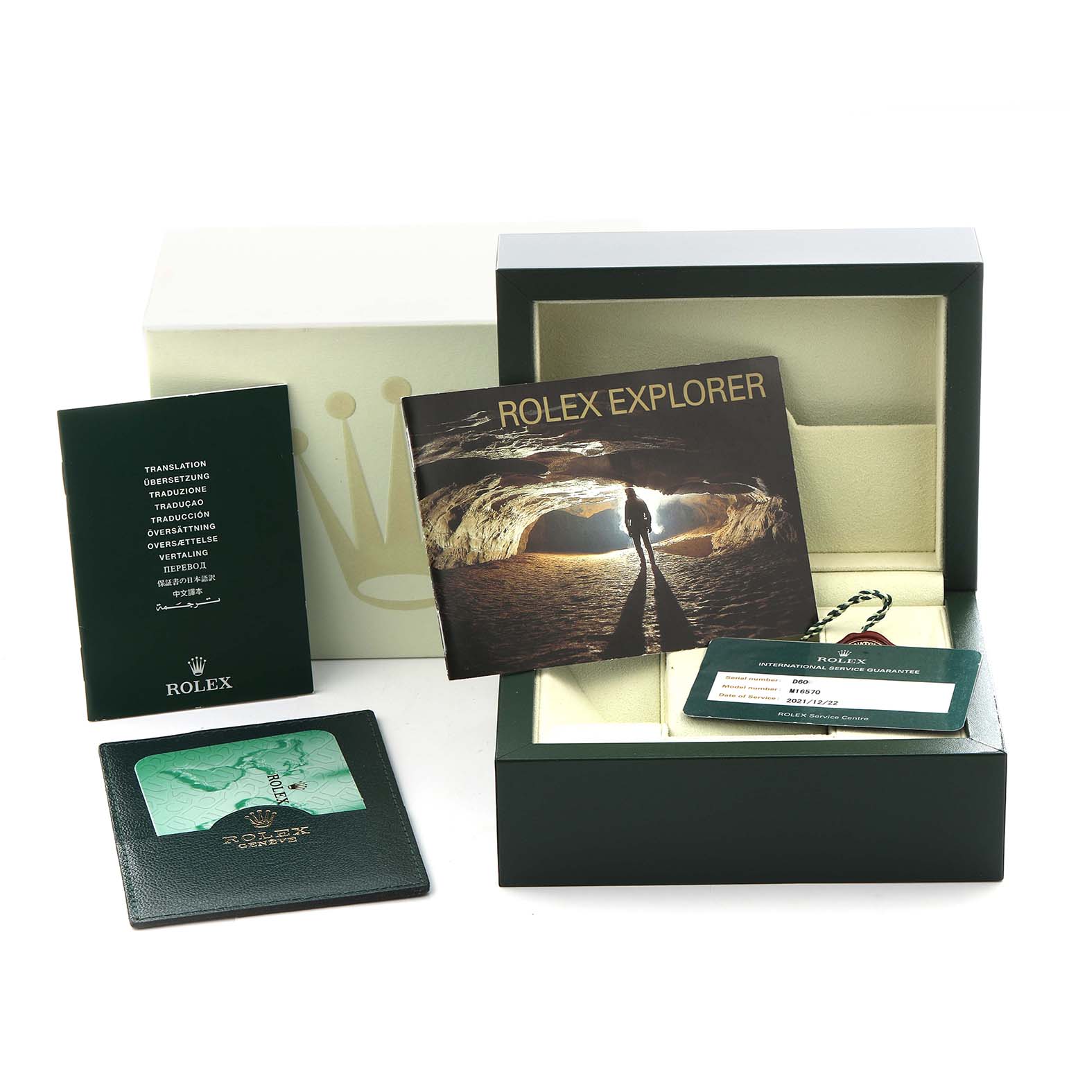 The Rolex Explorer 16570 Men's Stainless Steel White Dial 16570 Men's Stainless Steel White Dial accessories shown include the box, booklet, warranty card, and tag, all displayed from a top view.