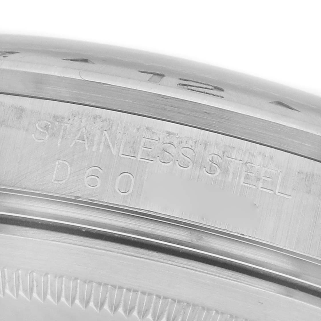 The image shows a close-up of the Rolex Explorer 16570 Men's Stainless Steel White Dial 16570 Men's Stainless Steel White Dial's stainless steel bezel, emphasizing the engraved markings.