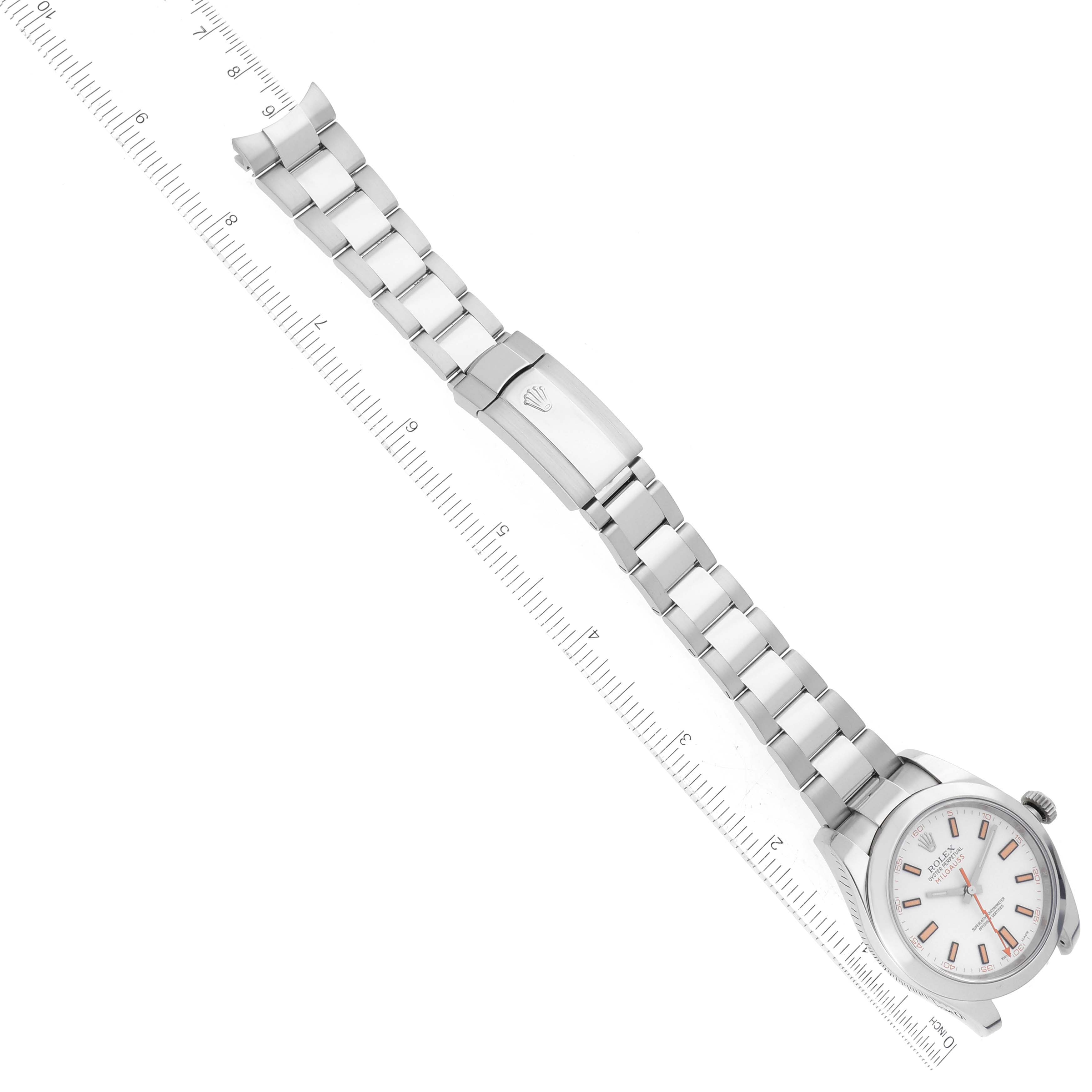 The image shows a Rolex Milgauss 116400 Men's Stainless Steel White Dial 116400 Men's Stainless Steel White Dial watch, angled to display the face, bracelet, and clasp, with a ruler alongside for measurement.