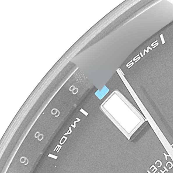 This close-up image shows part of the dial and date window of the Rolex Oyster Perpetual 114300 Men
s Stainless Steel Grey Dial 114300 Men
s Stainless Steel Grey Dial watch.