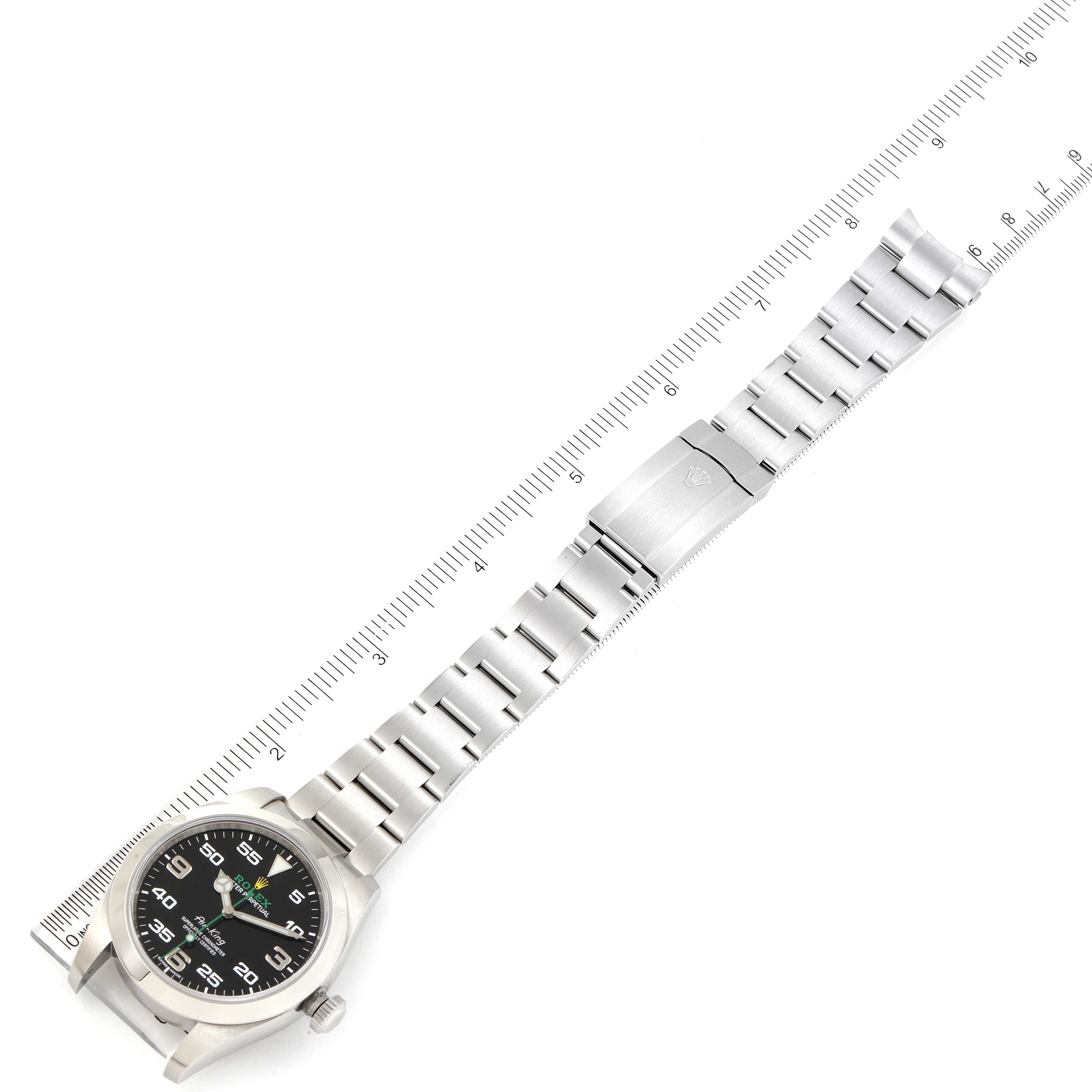 The image shows an overhead view of a Rolex Air-King 116900 Men's Stainless Steel Black Dial 116900 Men's Stainless Steel Black Dial watch, including the face, bracelet, and clasp, measured with a ruler.
