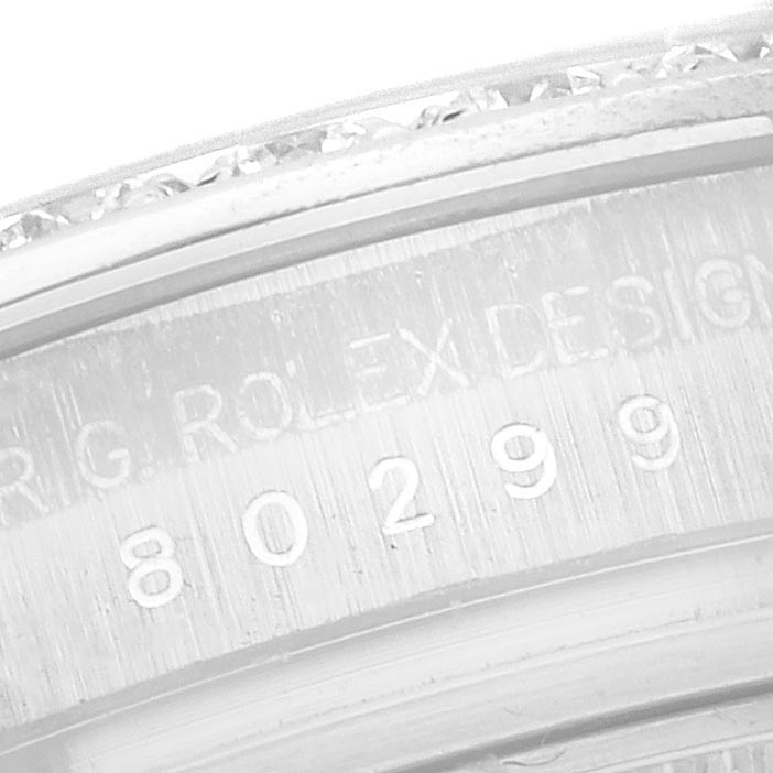 The image shows a close-up of the engraved bezel of a Rolex Pearlmaster 80299 Women
s White Gold Silver Dial 80299 Women
s White Gold Silver Dial watch.