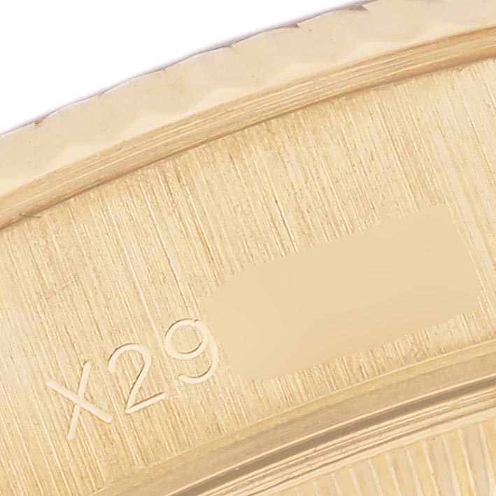 The image shows a close-up of the case back of the Rolex President 69178 Women
s Yellow Gold Black Dial 69178 Women
s Yellow Gold Black Dial model, highlighting the edge with some engravings.