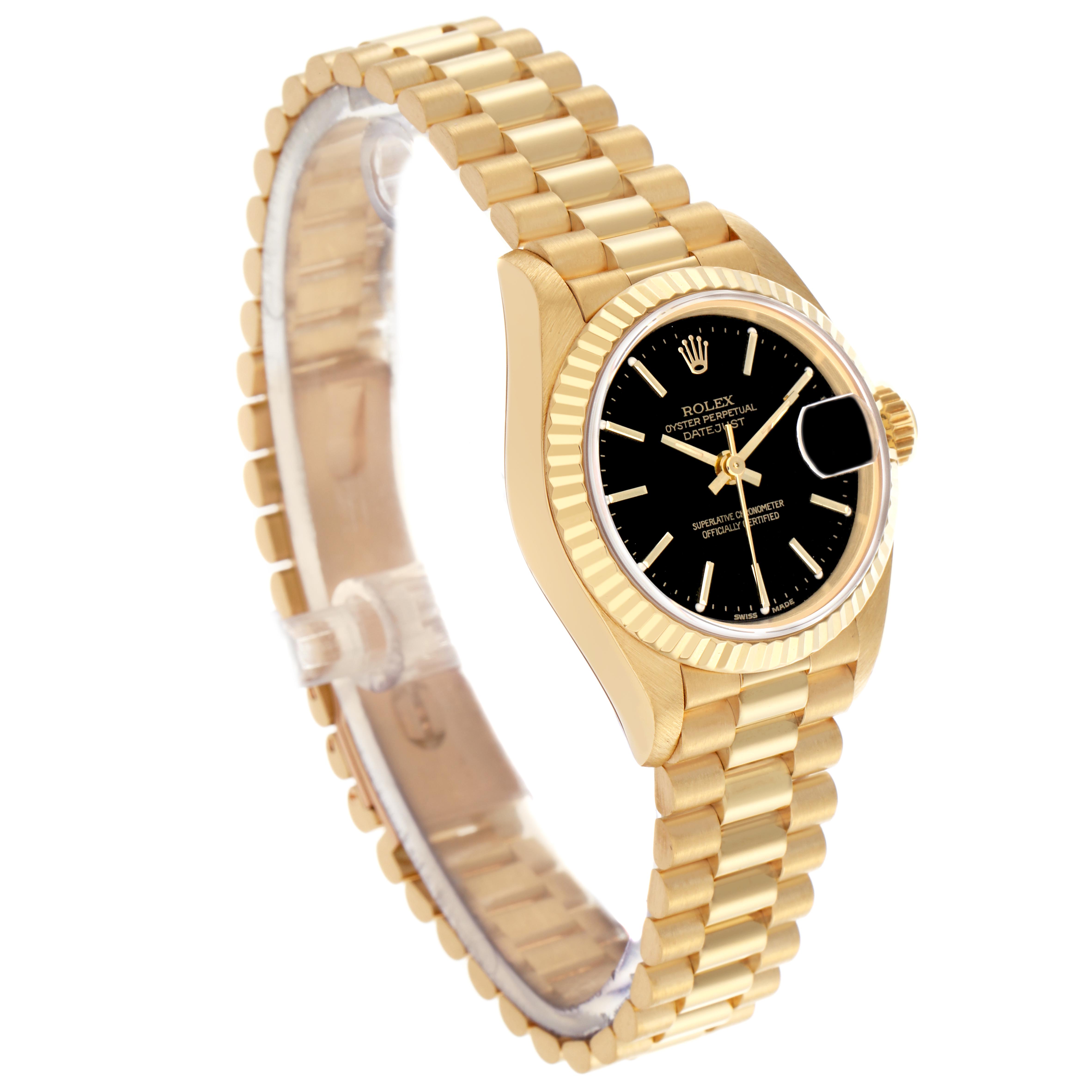The Rolex President 69178 Women
s Yellow Gold Black Dial 69178 Women
s Yellow Gold Black Dial model watch is shown at a slight angle, displaying its gold bracelet, black dial, and fluted bezel.