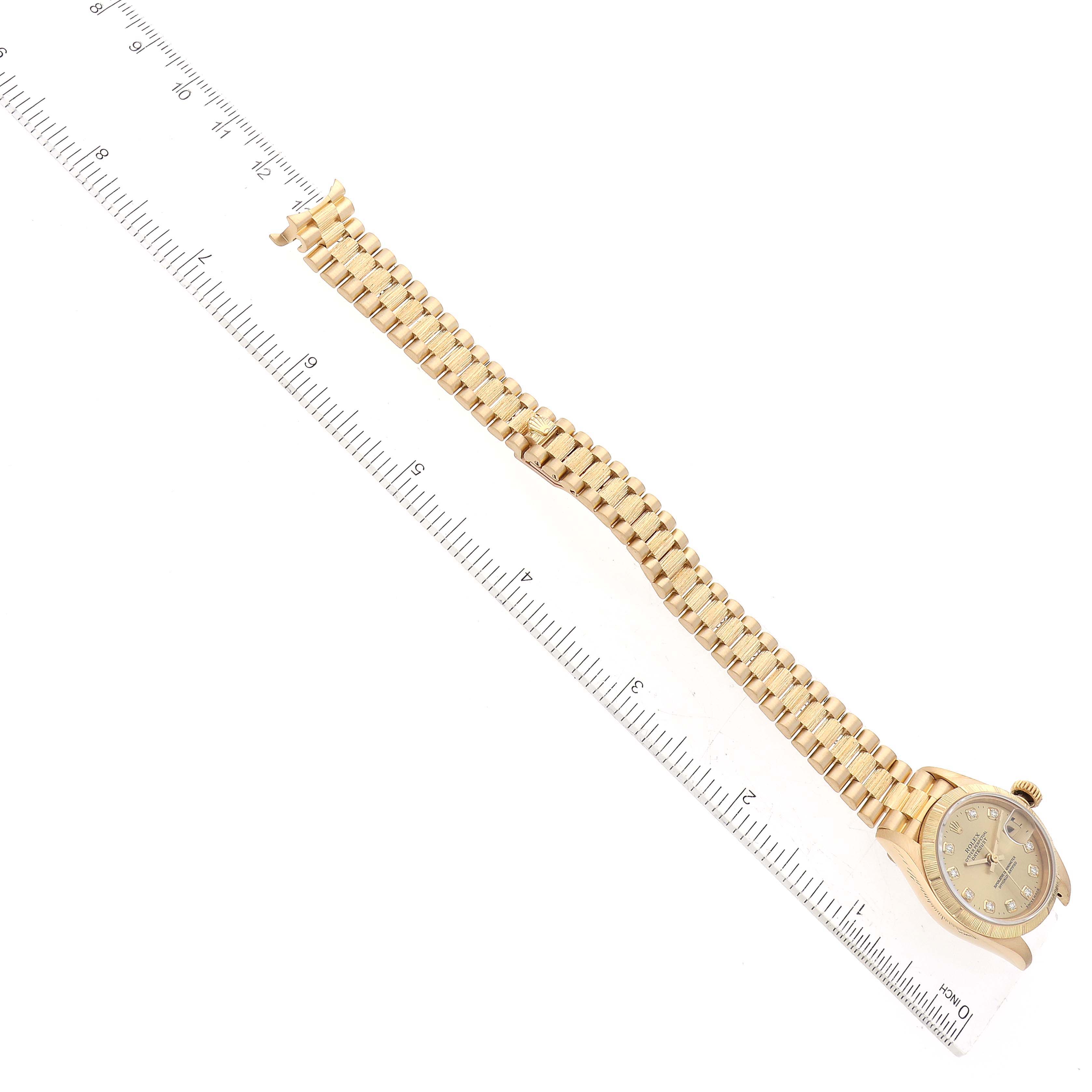 The image shows a Rolex President 79278 Women's Yellow Gold Champagne Dial 79278 Women's Yellow Gold Champagne Dial model watch laid flat with a ruler, displaying the face, bezel, and bracelet.