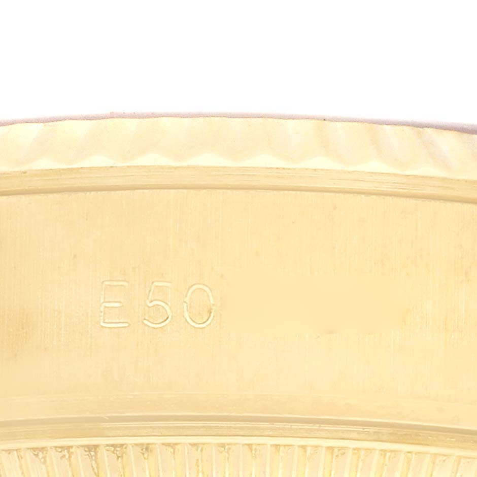 The image shows a close-up of the side of a Rolex President 69178 Women's Yellow Gold Champagne Dial 69178 Women's Yellow Gold Champagne Dial watch, highlighting its gold case with engraving.