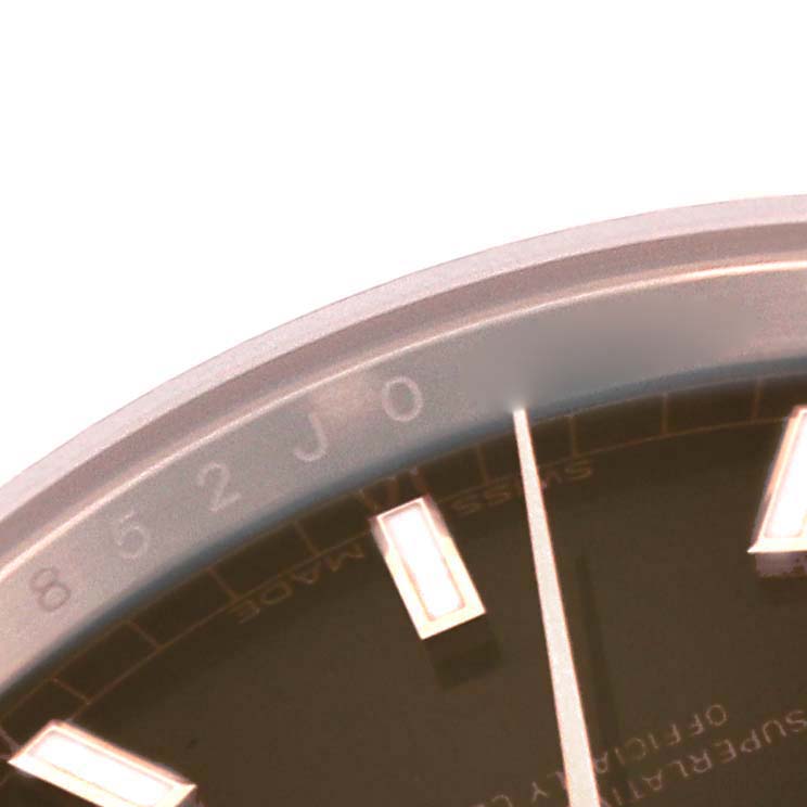 This is a close-up of the Rolex President 118135 Men's Rose Gold Brown Dial 118135 Men's Rose Gold Brown Dial model watch, showing part of the dial, indices, and bezel.