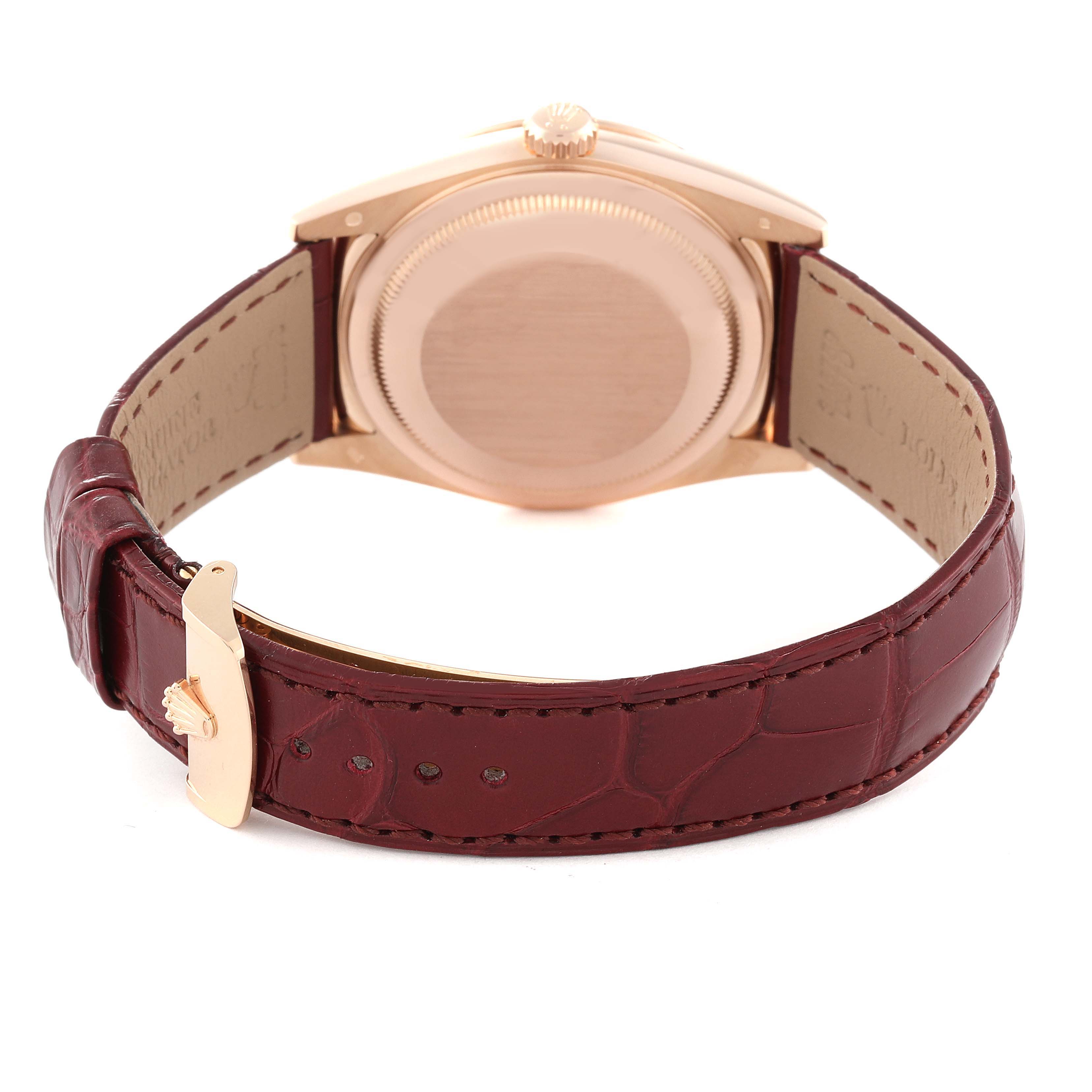 The image shows the back of the Rolex President 118135 Men's Rose Gold Brown Dial 118135 Men's Rose Gold Brown Dial model watch, featuring its case back and burgundy leather strap with a clasp.