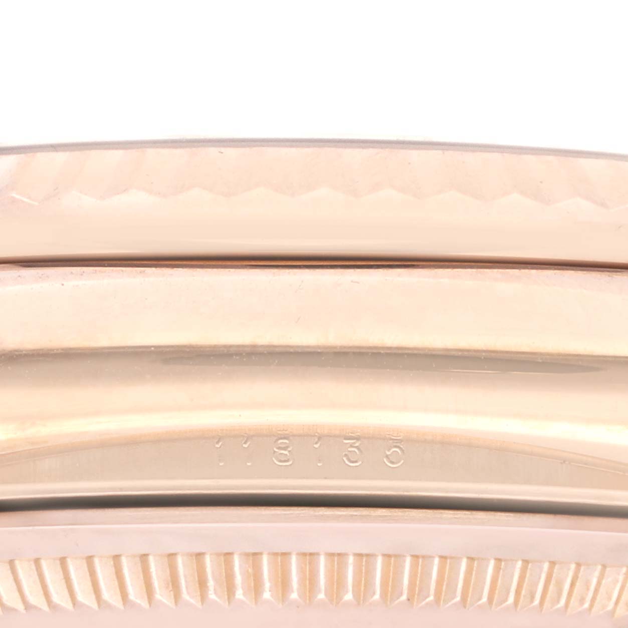 This image shows a close-up of the side of a Rolex President 118135 Men's Rose Gold Brown Dial 118135 Men's Rose Gold Brown Dial model watch case, highlighting the part with the engraved model number "118135".