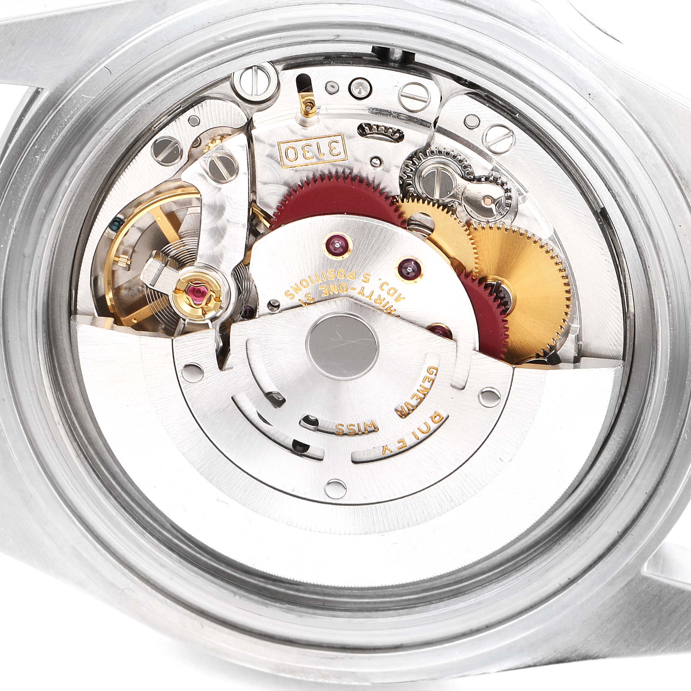 The image shows a close-up view of the movement inside a Rolex Submariner 14060M Men
s Stainless Steel Black Dial 14060M Men
s Stainless Steel Black Dial watch, focusing on its intricate mechanical parts.