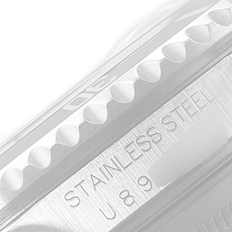 The image shows a close-up of the bezel and case side of a Rolex Submariner 16610 Men
s Stainless Steel Black Dial 16610 Men
s Stainless Steel Black Dial watch, revealing the "STAINLESS STEEL" engraving.