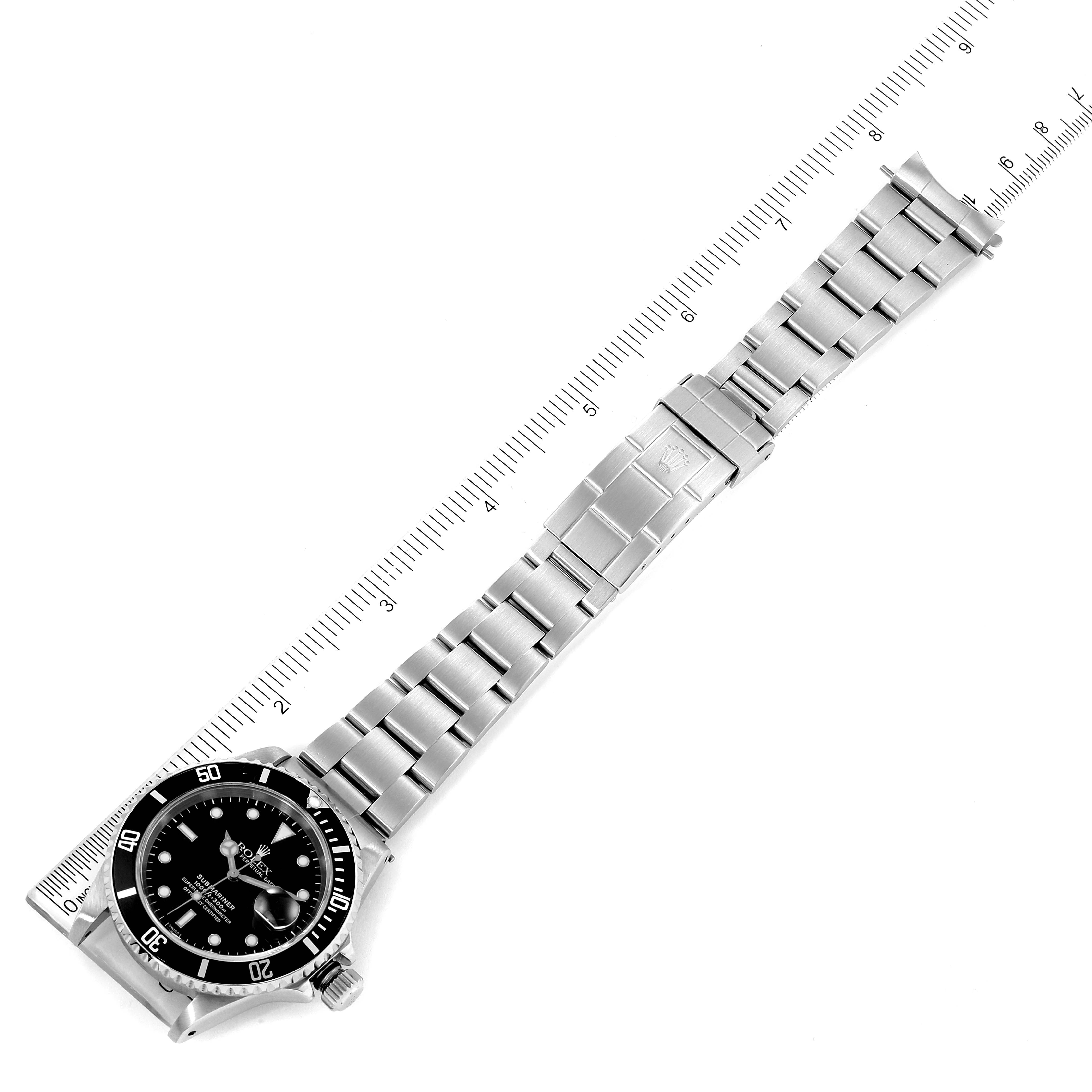 The image shows a Rolex Submariner 16610 Men
s Stainless Steel Black Dial 16610 Men
s Stainless Steel Black Dial watch laid flat, highlighting its stainless steel bracelet, clasp, and bezel.
