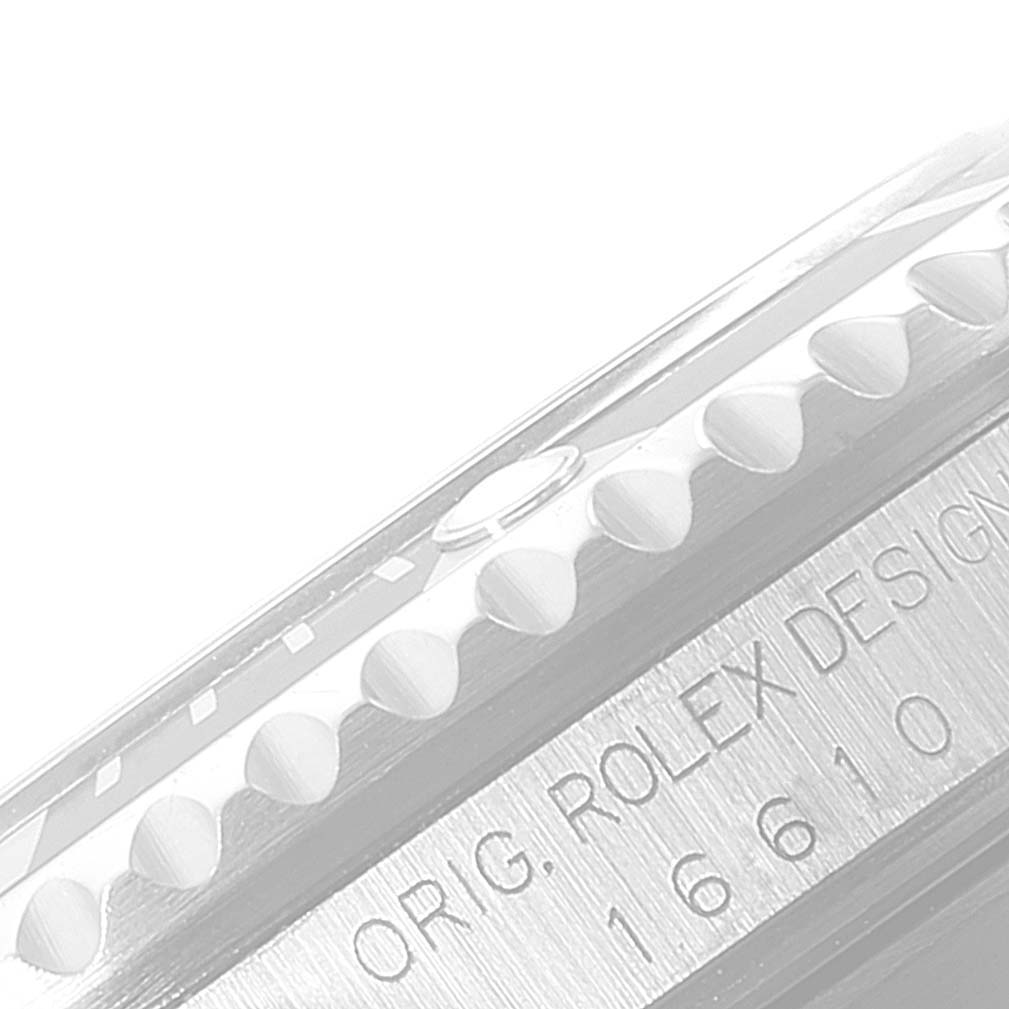 The image shows a close-up of the side profile of a Rolex Submariner 16610 Men
s Stainless Steel Black Dial 16610 Men
s Stainless Steel Black Dial, highlighting the bezel and case engraving with model number 16610.