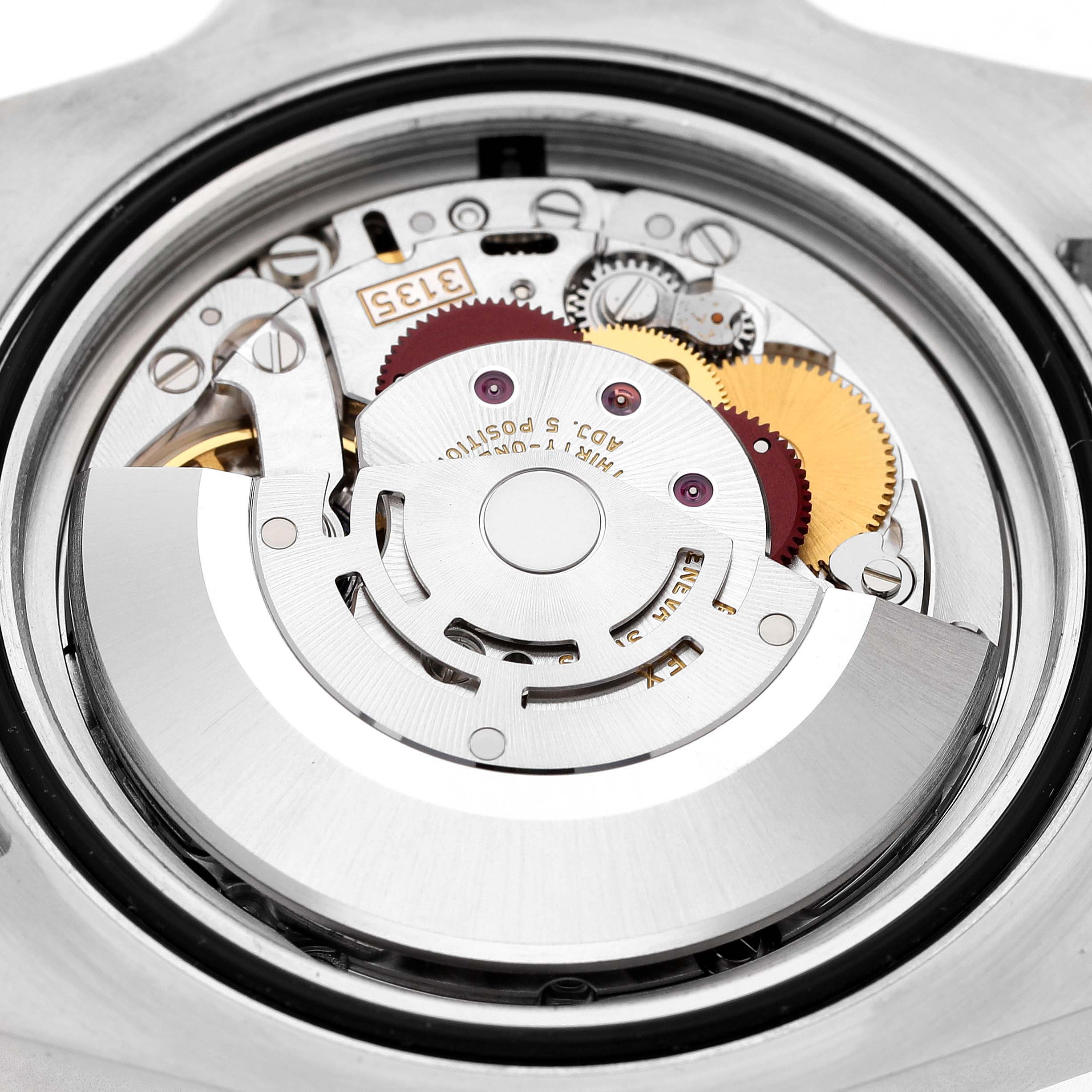 The image shows the movement mechanism of a Rolex Submariner 116610LN Men's Stainless Steel Black Dial watch from the back, highlighting gears and components.