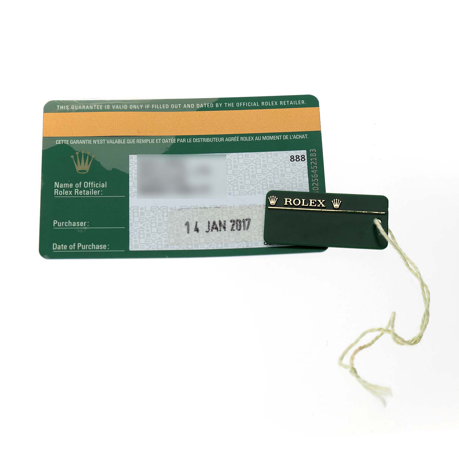The image shows a Rolex Submariner 116610LN Men's Stainless Steel Black Dial warranty card and a green tag with the Rolex logo and branding.