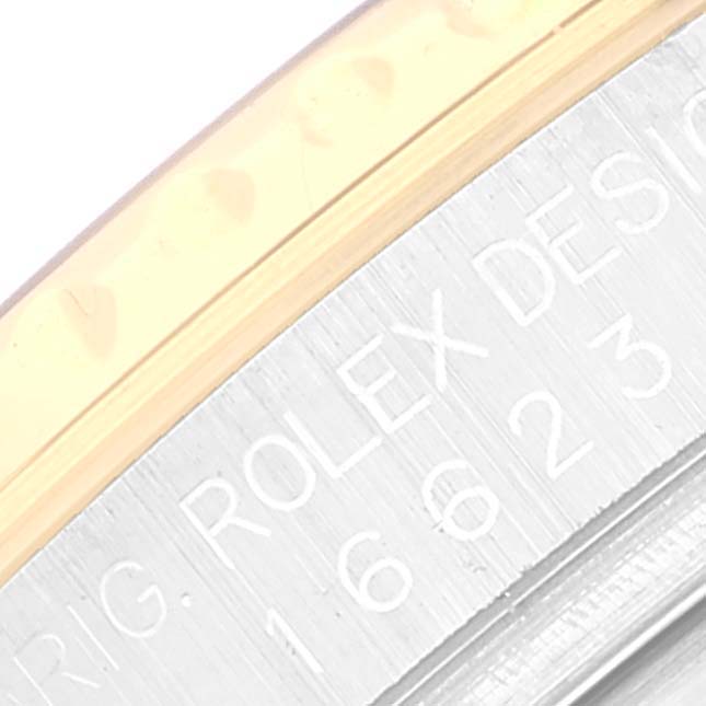 The image shows a close-up view of the engraved bezel and case of a Rolex Yacht-Master 16623 Men
s Steel and Gold (two tone) White Dial 16623 Men
s Steel and Gold (two tone) White Dial watch.