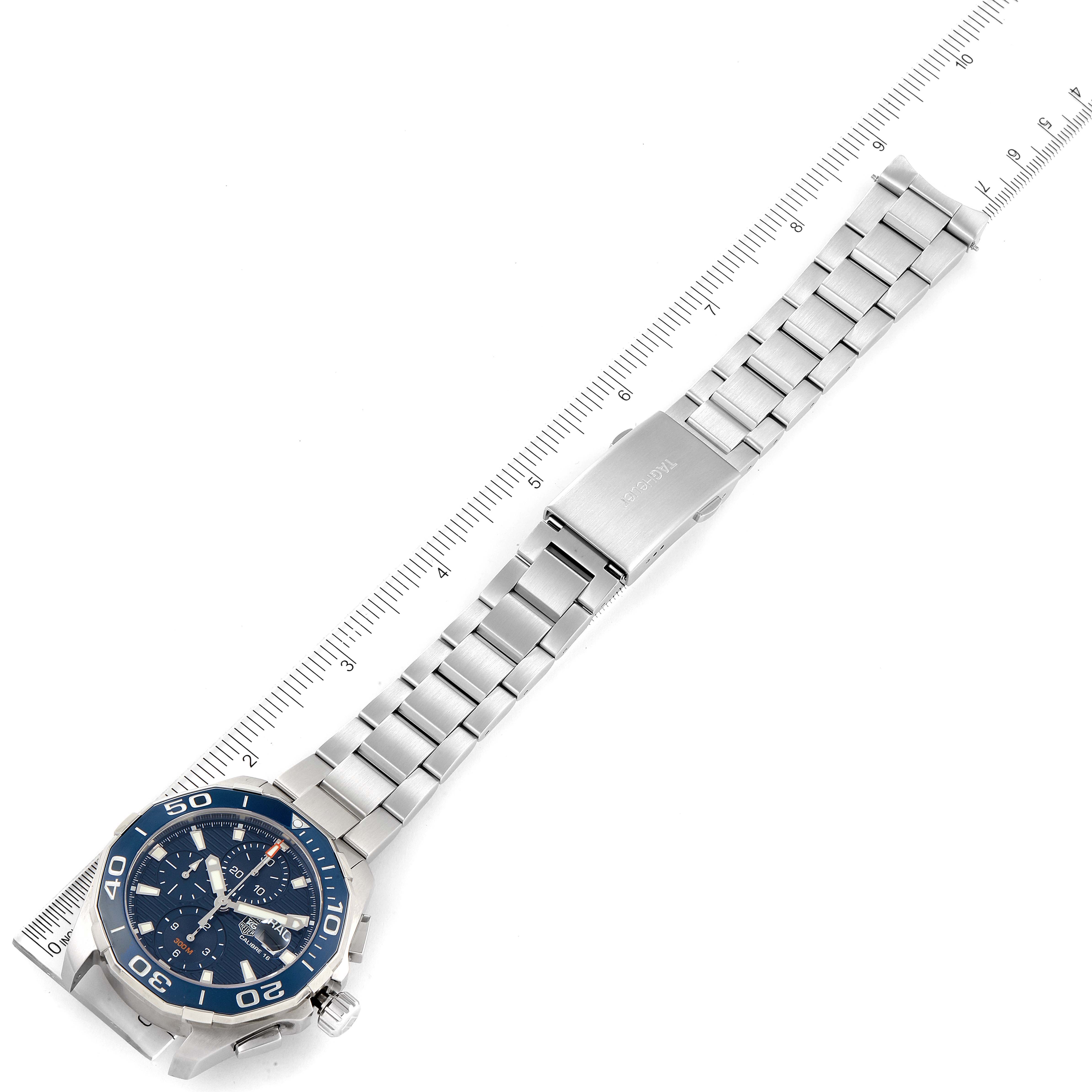 The image shows a Tag Heuer Aquaracer CAY211B.BA0927 Men's Stainless Steel Blue Dial CAY211B.BA0927 Men's Stainless Steel Blue Dial watch laid flat with its metal bracelet extended, alongside a ruler for scale.