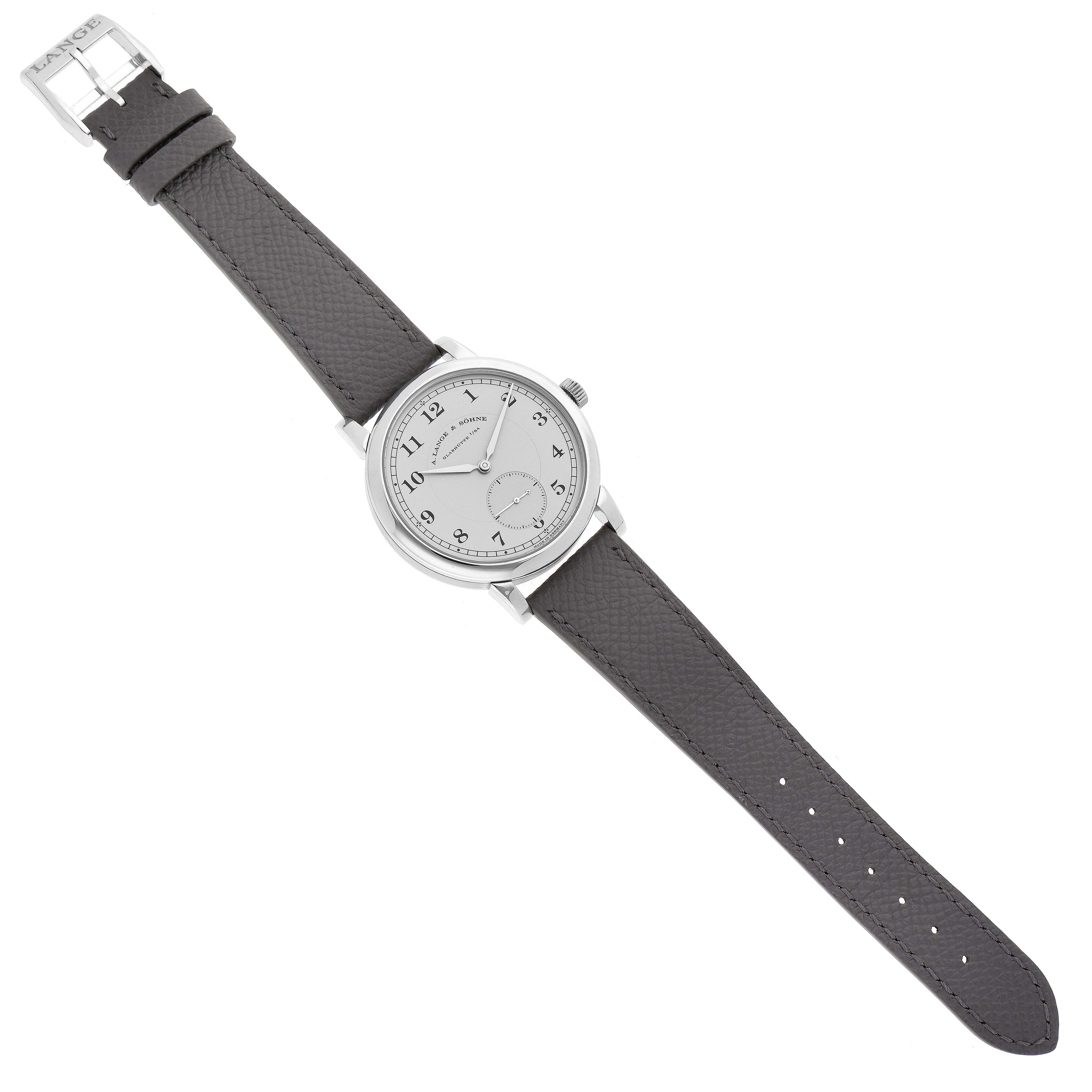 The 1815 model by A. Lange & Söhne is shown from an aerial view with its full leather strap and clasp visible.