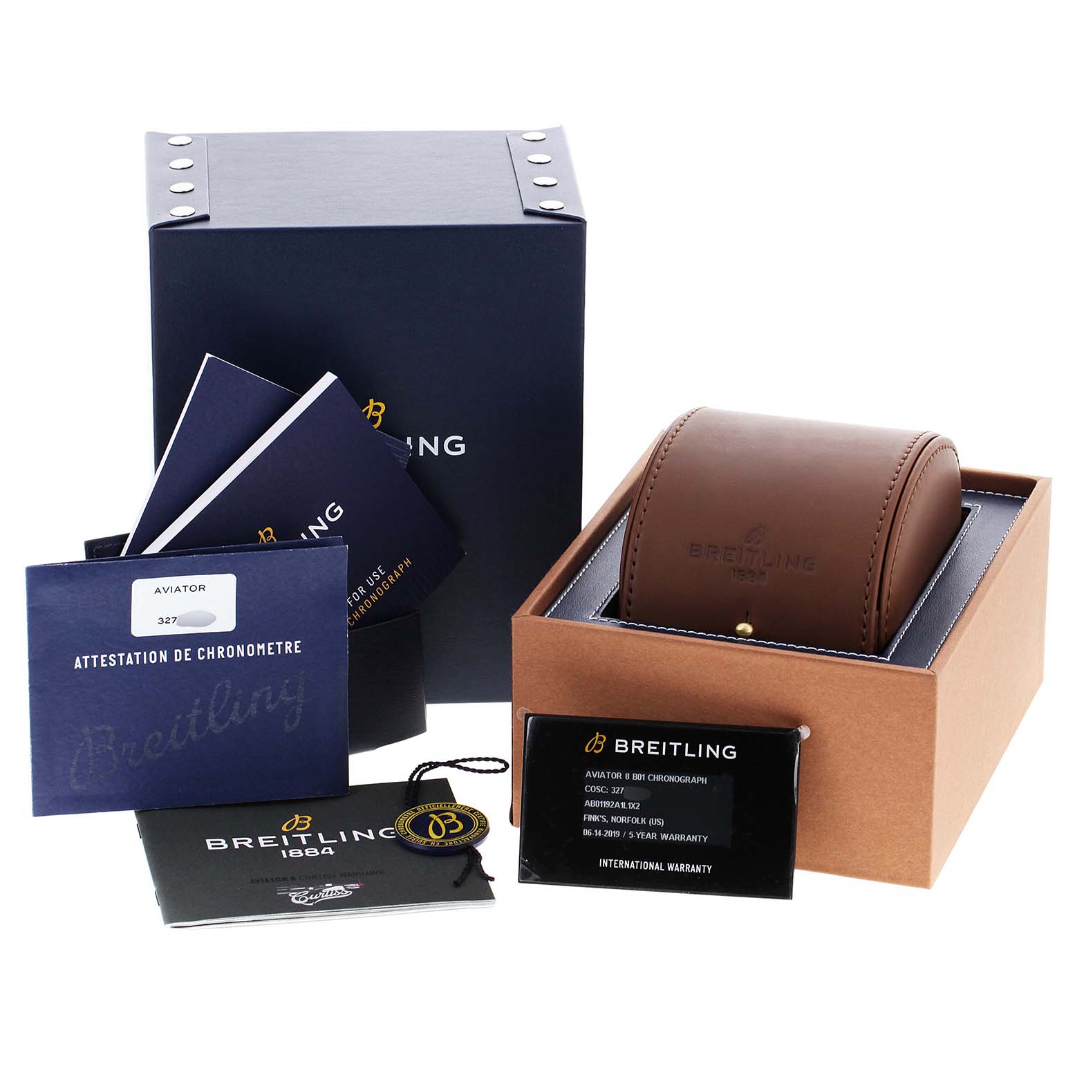 This image shows the packaging and accessories for a Breitling Navitimer watch, including the box, watch case, manuals, and warranty card.