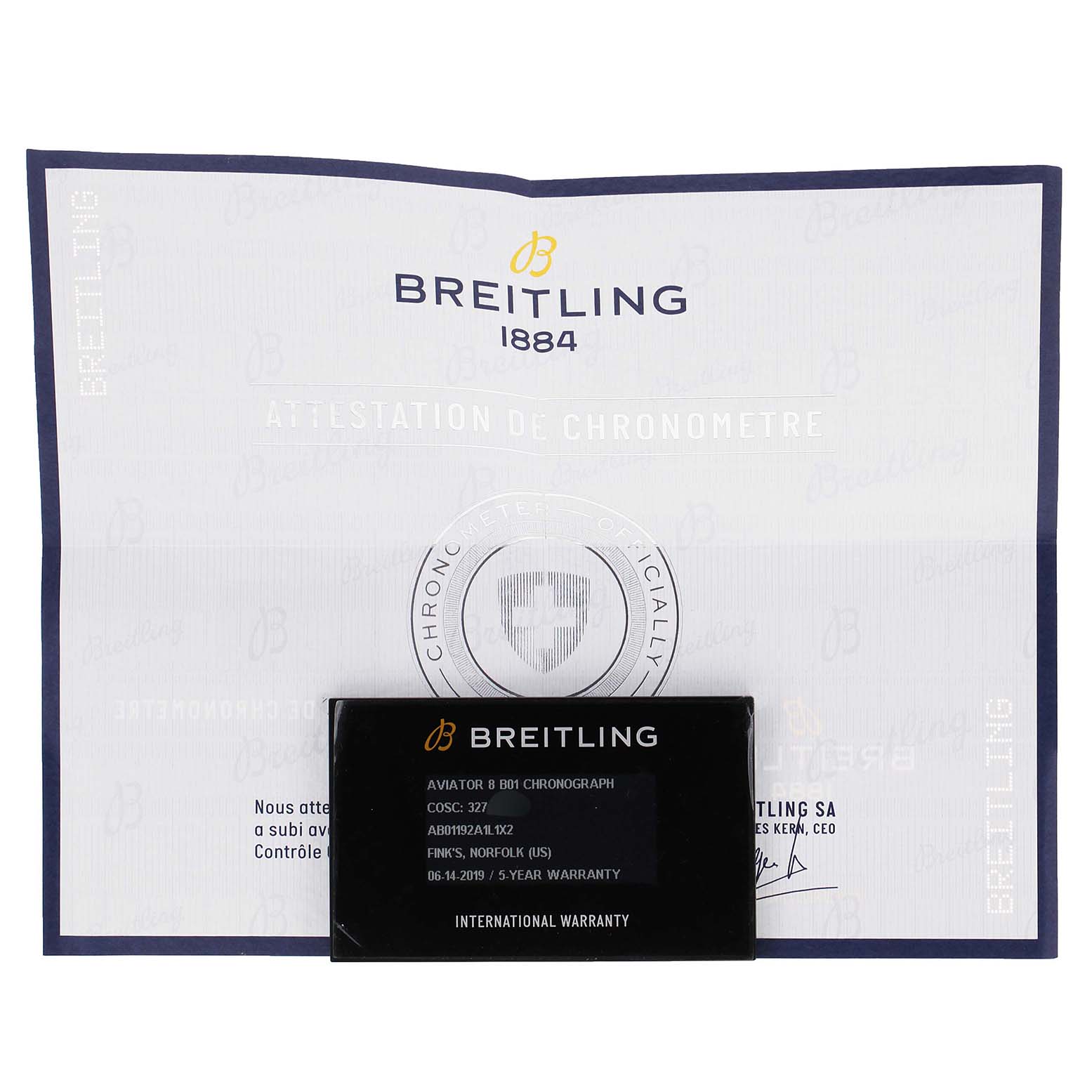 This image shows the international warranty card and certificate of the Breitling Navitimer watch, laying flat.