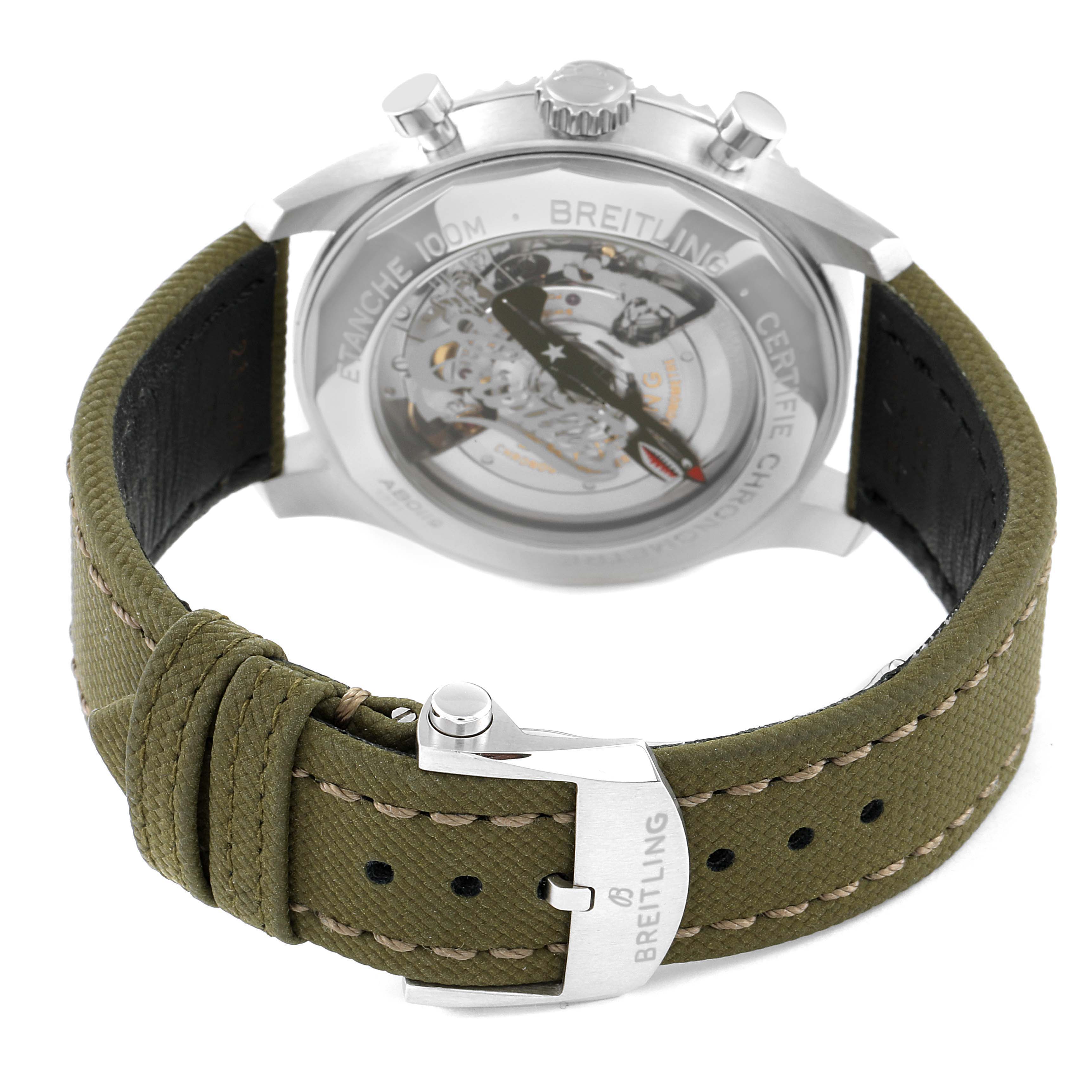 This image shows the back view of a Breitling Navitimer watch with a clear case back and an olive green strap.