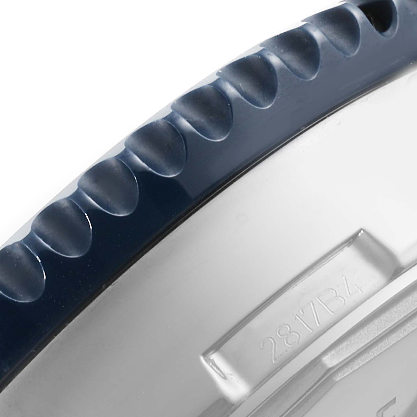 This image shows a close-up of the bezel and part of the case of a Breitling Chronoliner Y24310 Men's Stainless Steel Blue Dial Y24310 Men's Stainless Steel Blue Dial watch.