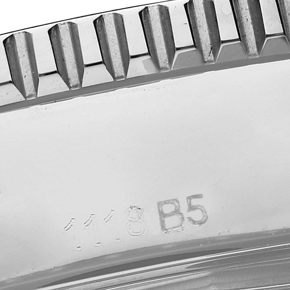 The image shows a close-up of the bezel and part of the case with engravings of a Breitling Superocean A17365 Men's Stainless Steel Black Dial A17365 Men's Stainless Steel Black Dial watch.