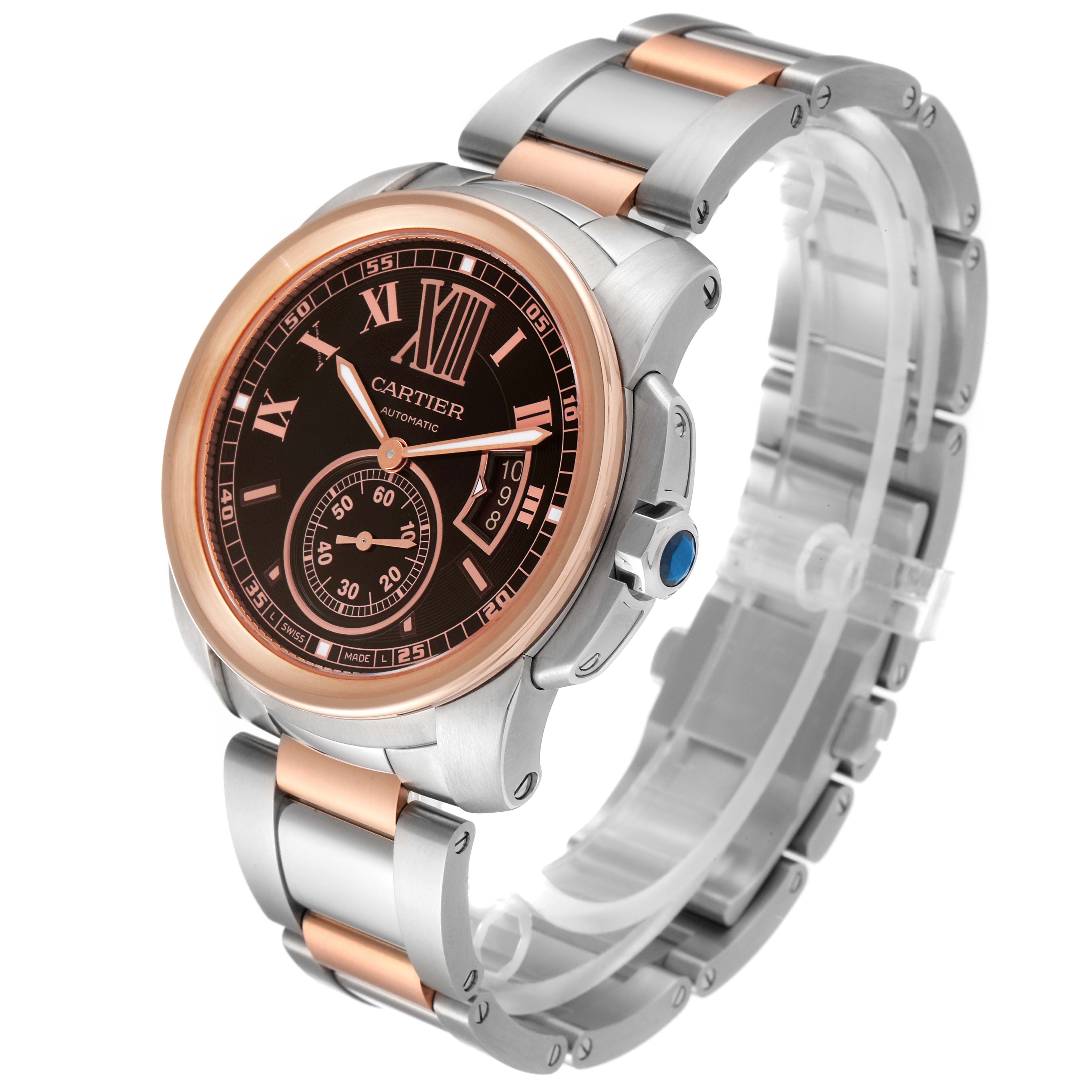 The Calibre de Cartier watch is shown at a 3/4 angle, highlighting its face, bezel, and metallic strap.