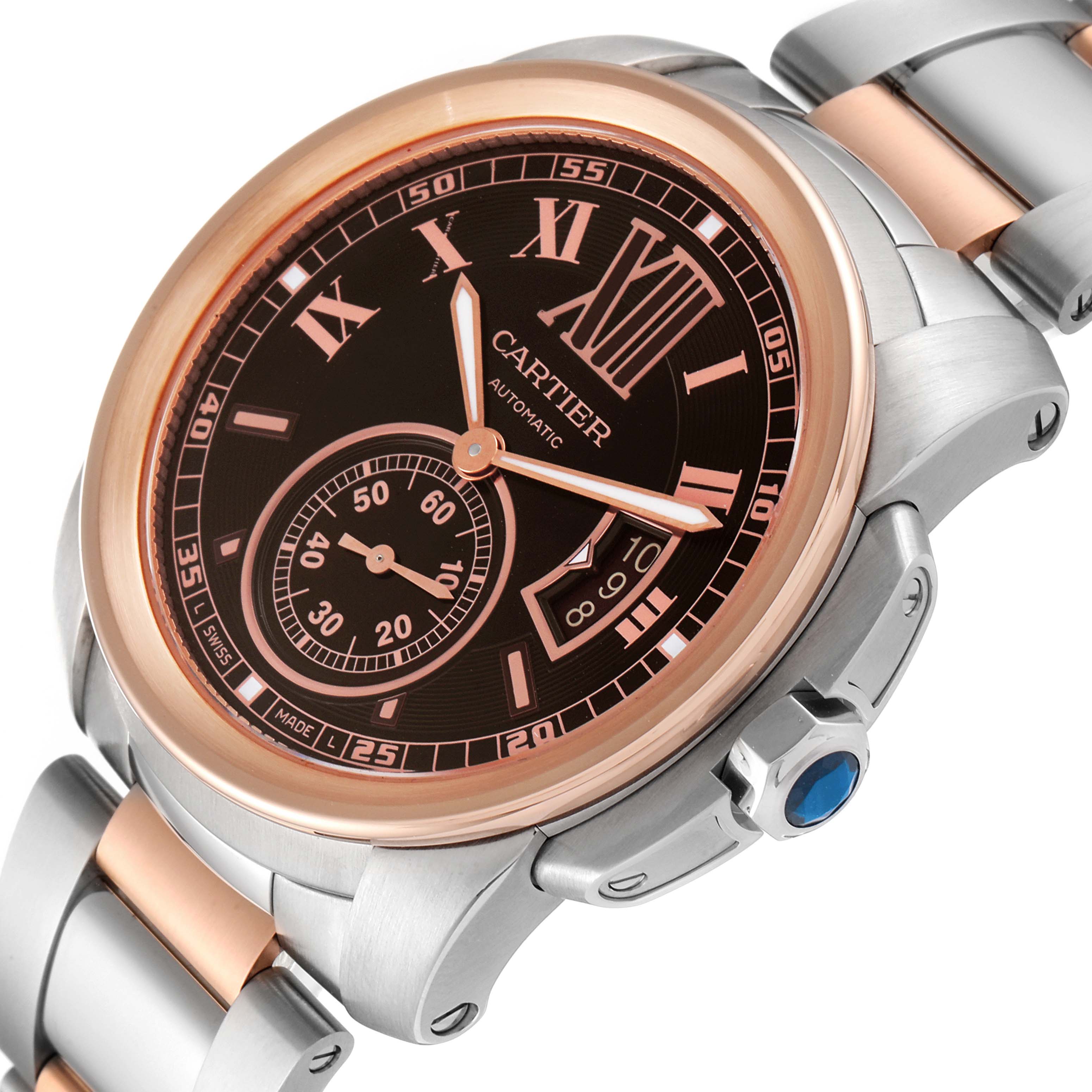 The image shows a close-up of the face and part of the bracelet of a Calibre de Cartier by Cartier watch at an angle.